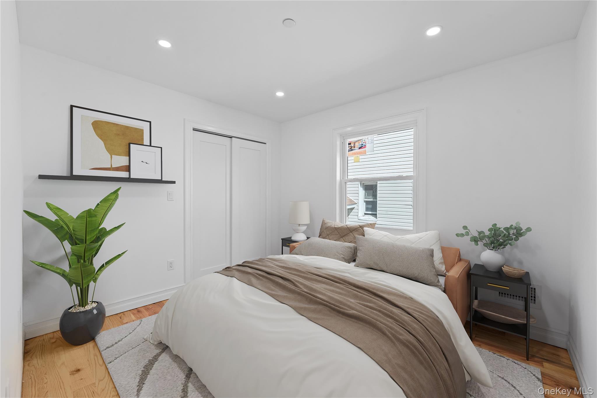 258-14 147th Road Queens, NY 11422 - Photo 9 of 22 Bedroom featuring light wood-style floors, recessed lighting, and a closet