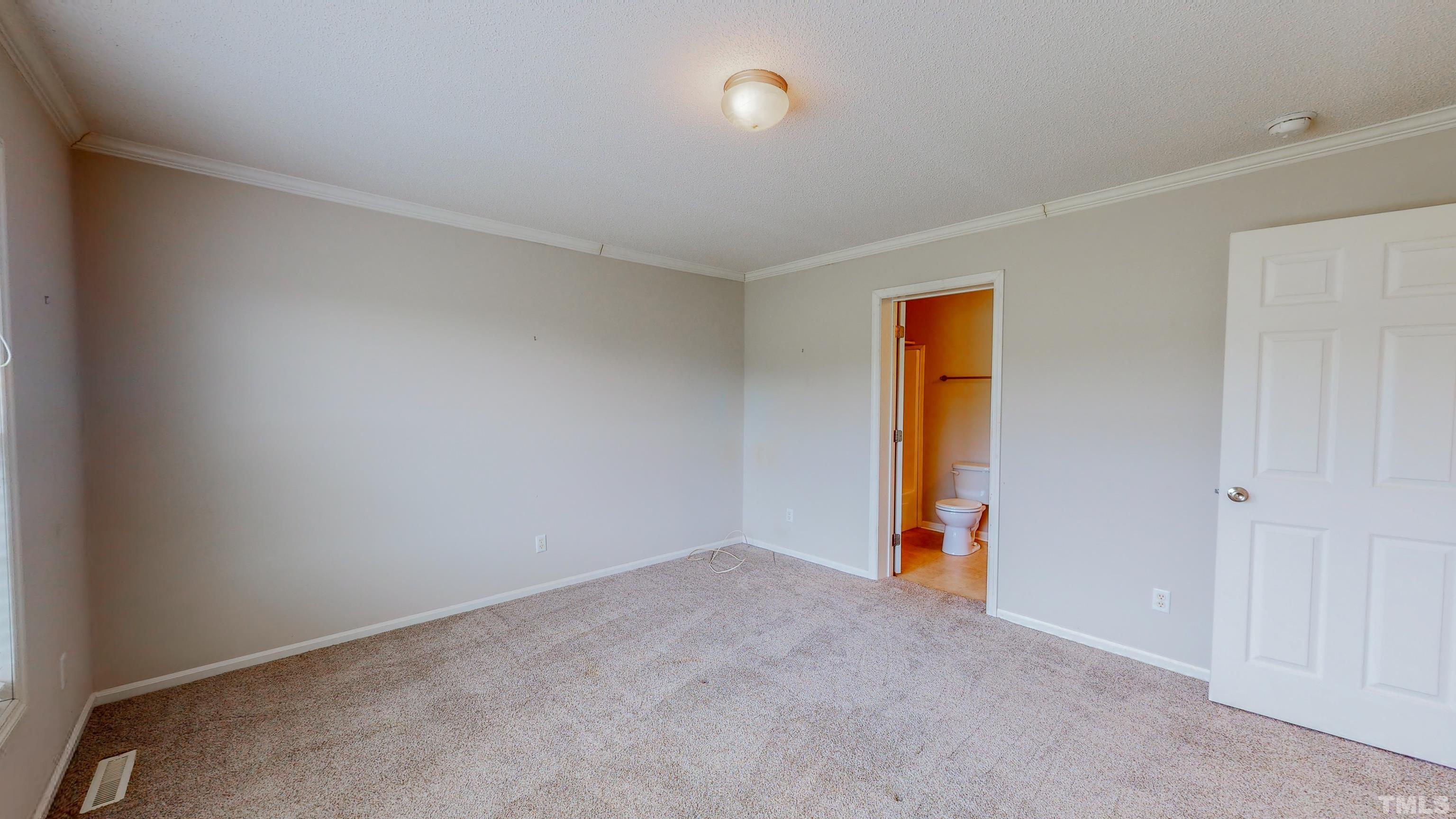 147 Quartergate Road Roxboro, NC 27574 - Photo 11 of 30 an empty room with an entryway and a window