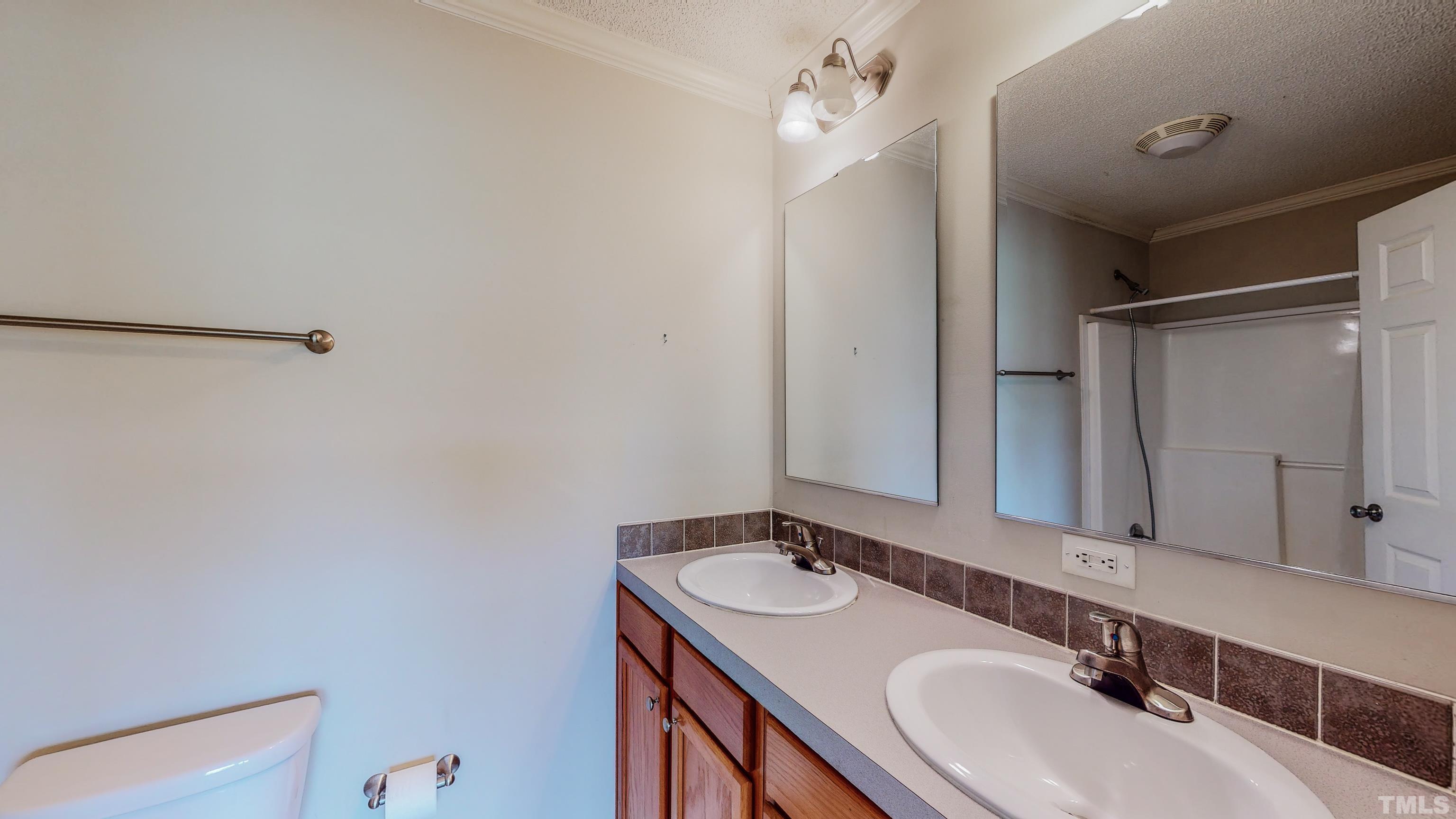 147 Quartergate Road Roxboro, NC 27574 - Photo 14 of 30 a bathroom with a sink and a mirror