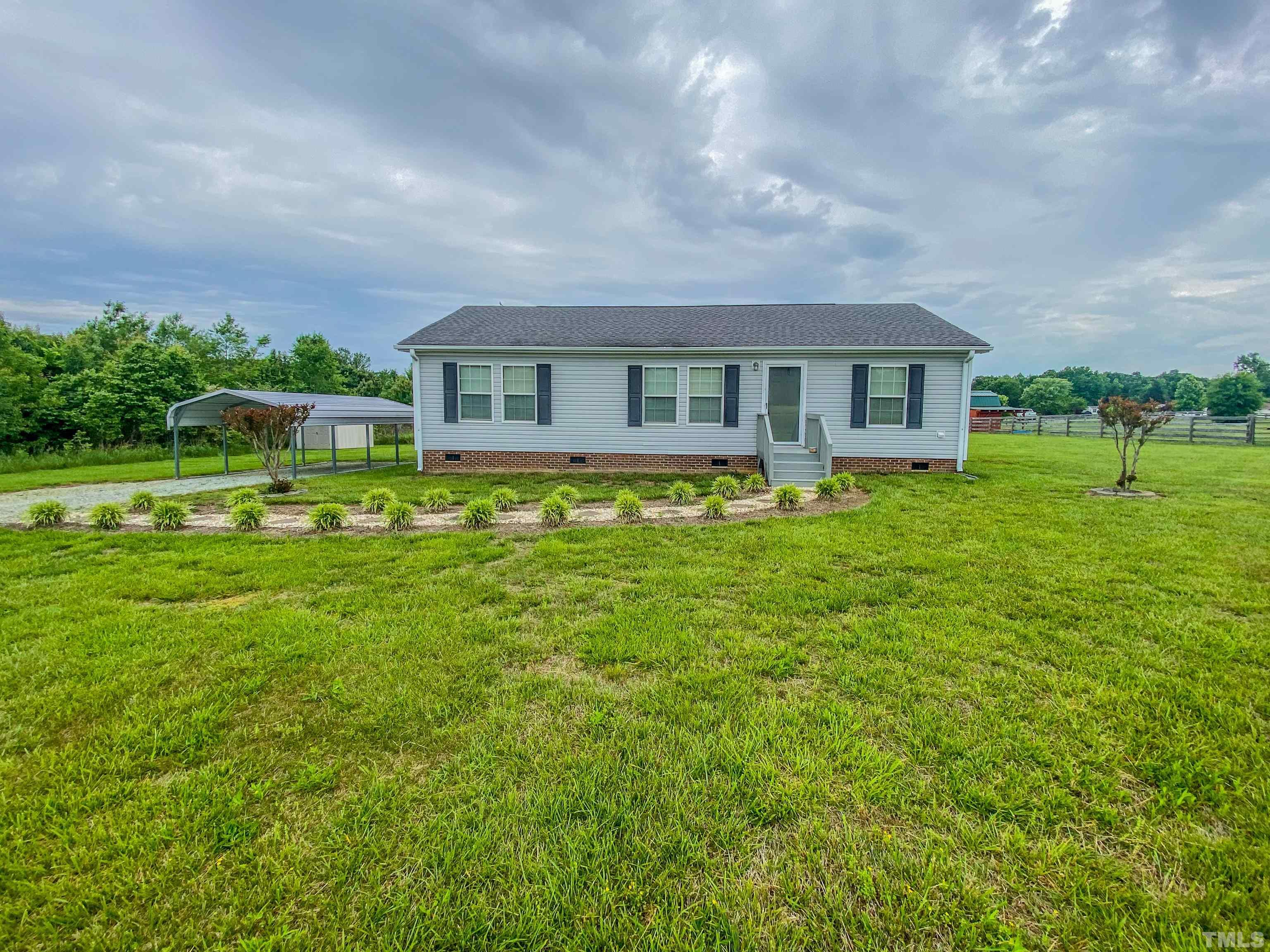 147 Quartergate Road Roxboro, NC 27574 - Photo 17 of 30 a front view of house with yard and green space