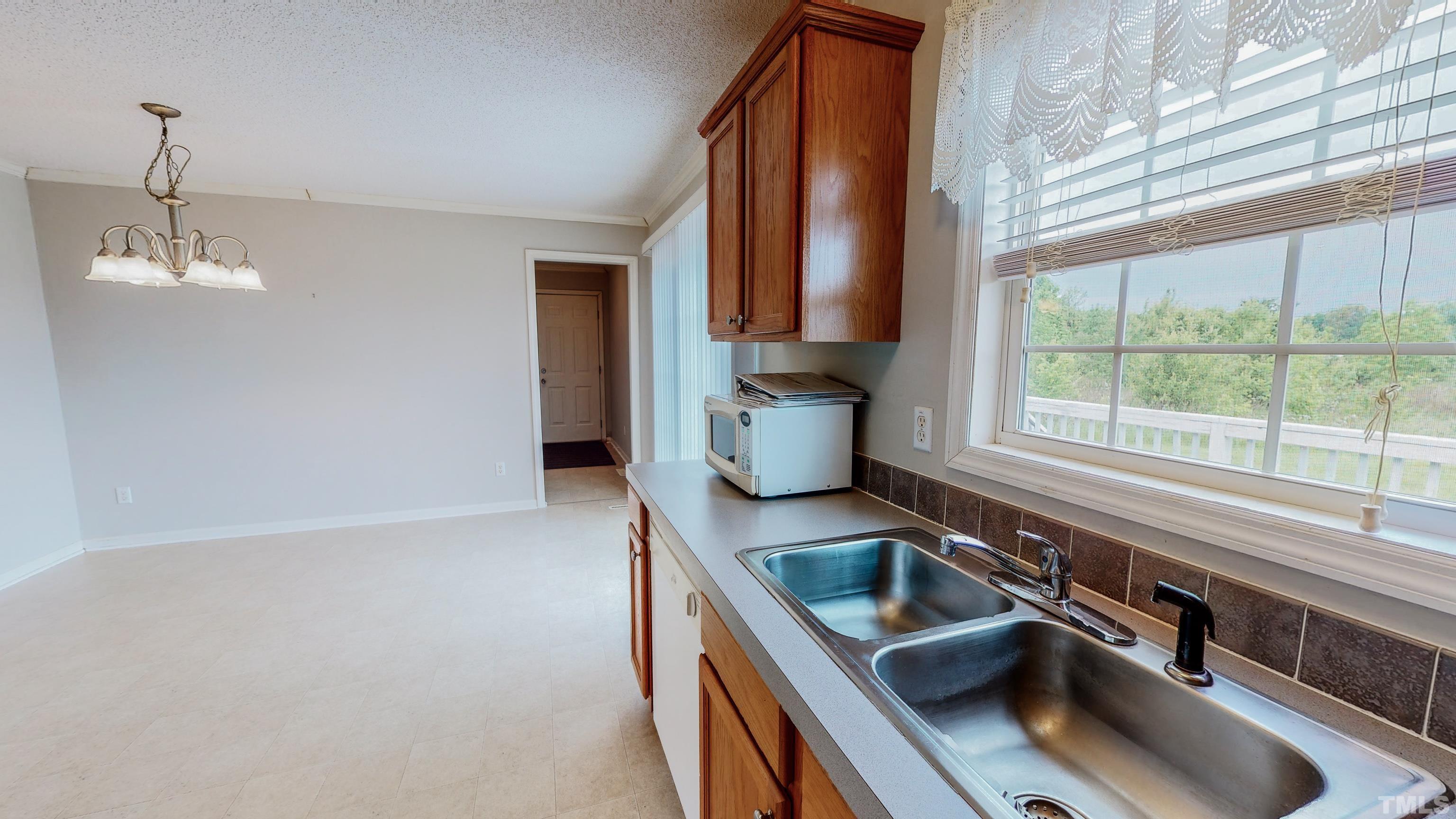 147 Quartergate Road Roxboro, NC 27574 - Photo 20 of 30 a kitchen with a sink a counter top space and cabinets