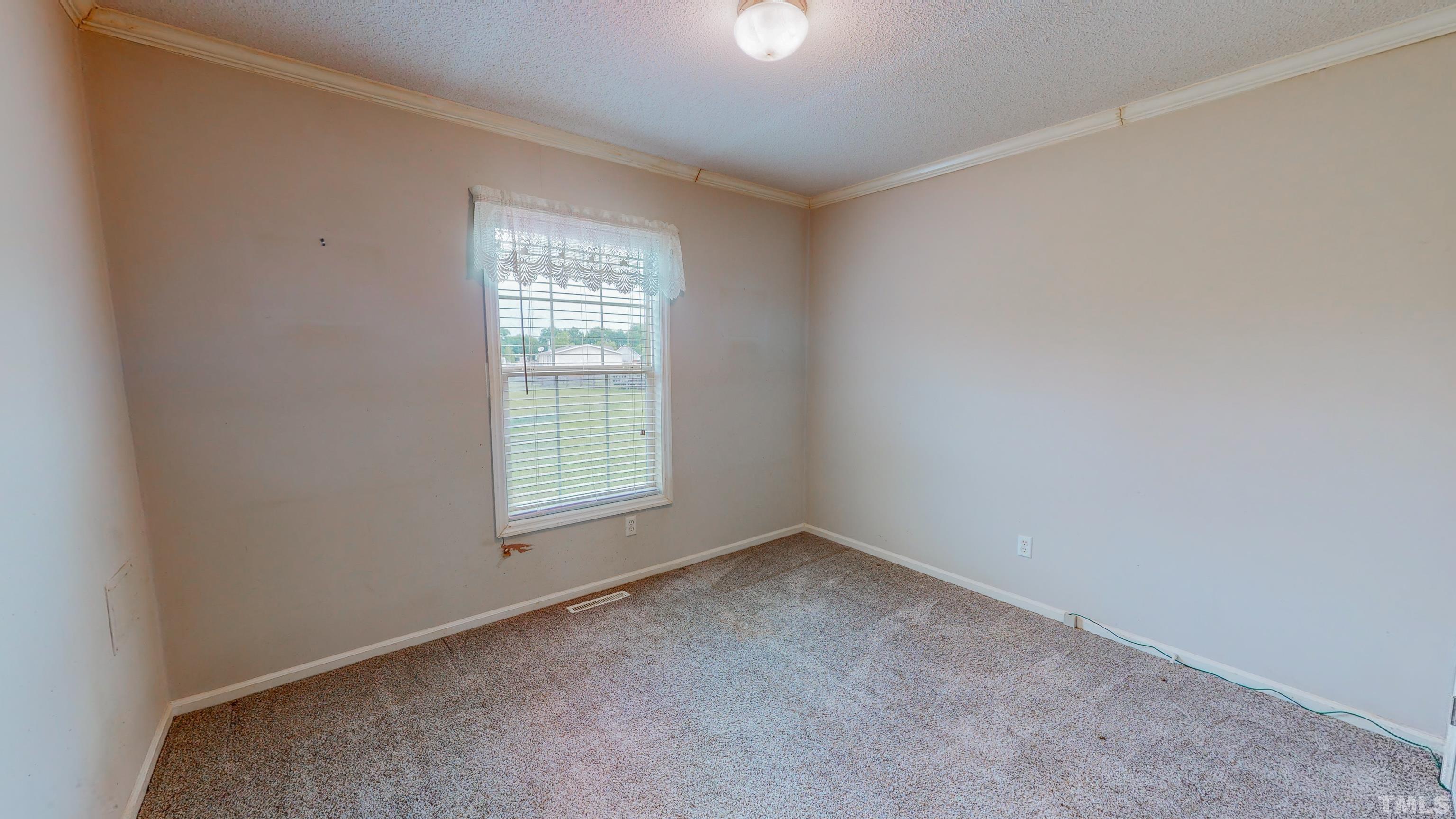 147 Quartergate Road Roxboro, NC 27574 - Photo 22 of 30 a view of an empty room with a window