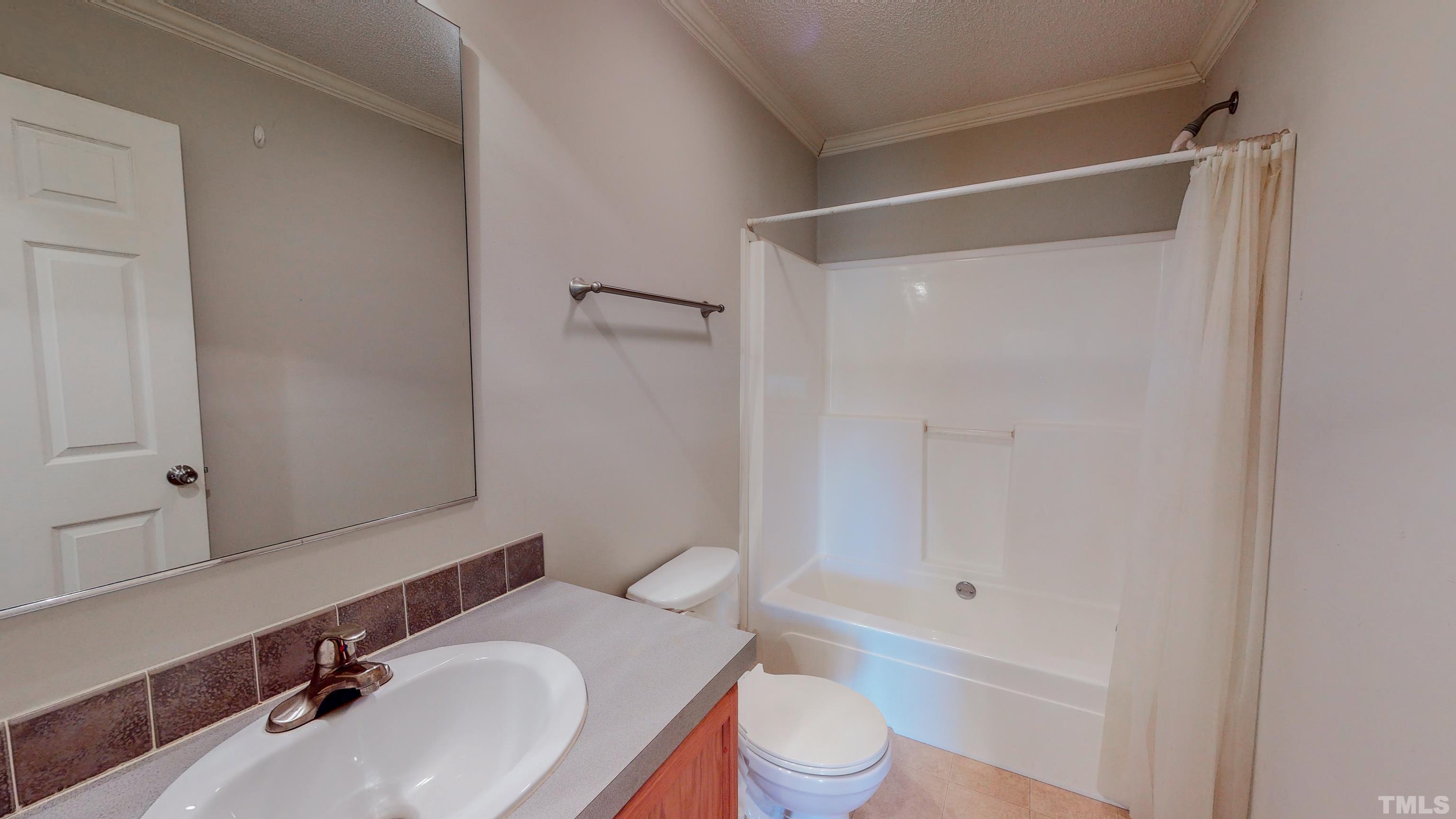 147 Quartergate Road Roxboro, NC 27574 - Photo 26 of 30 a bathroom with a sink toilet vanity and shower