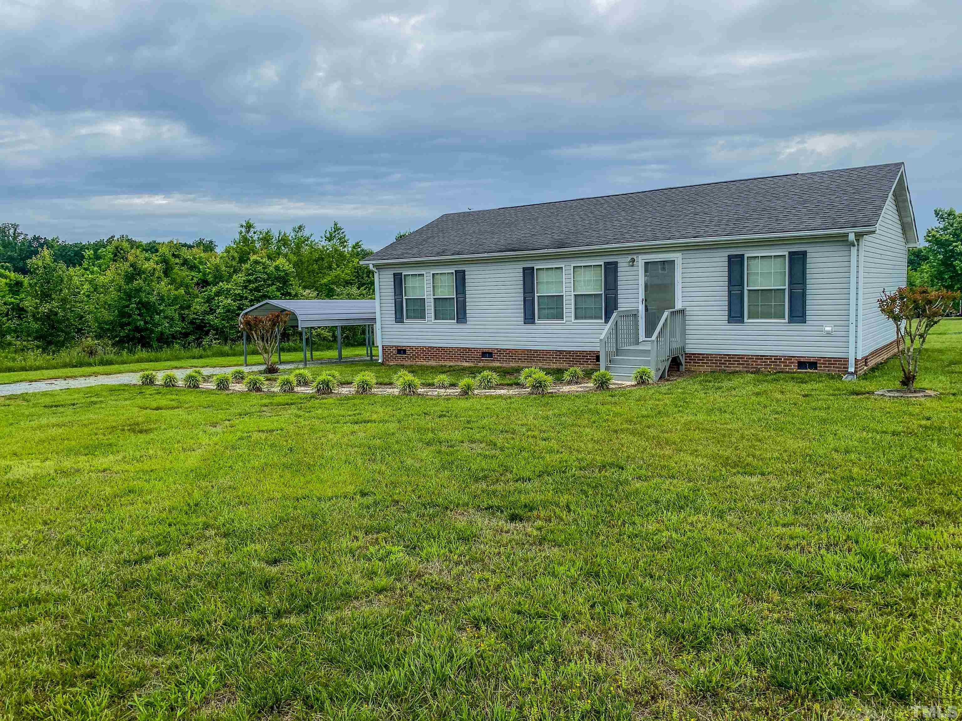 147 Quartergate Road Roxboro, NC 27574 - Photo 28 of 30 a house view with swimming pool and garden