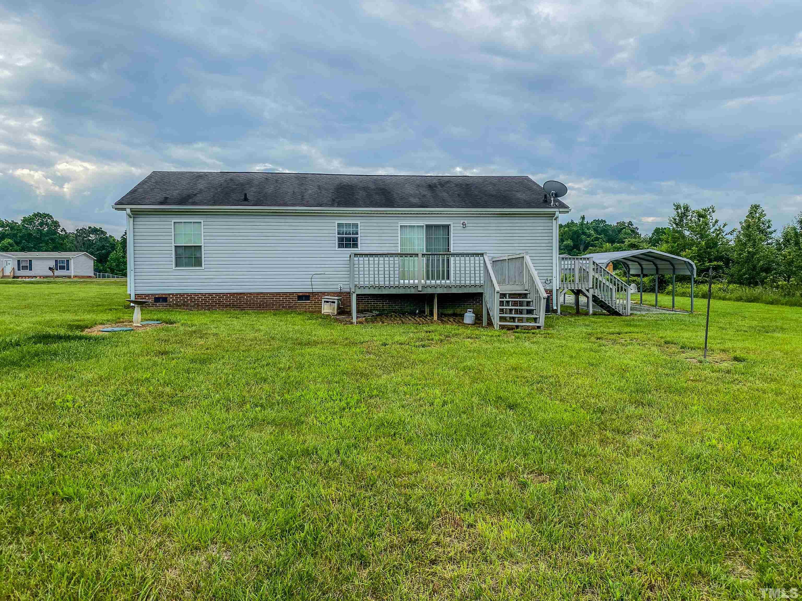 147 Quartergate Road Roxboro, NC 27574 - Photo 29 of 30 a backyard of a house with table and chairs