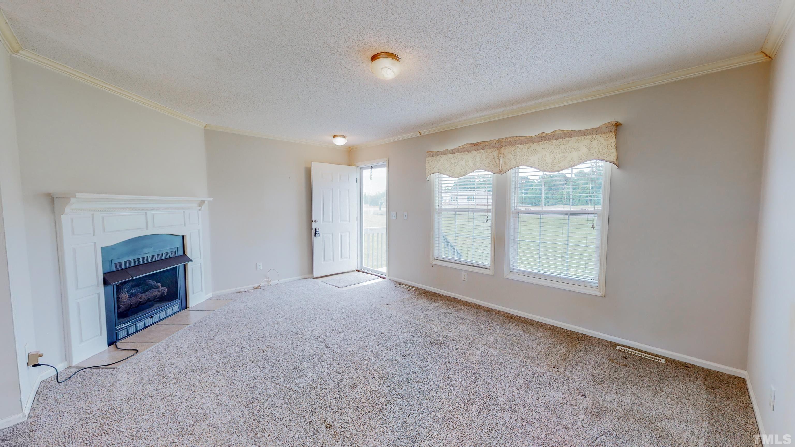 147 Quartergate Road Roxboro, NC 27574 - Photo 3 of 30 an empty room with windows and closet