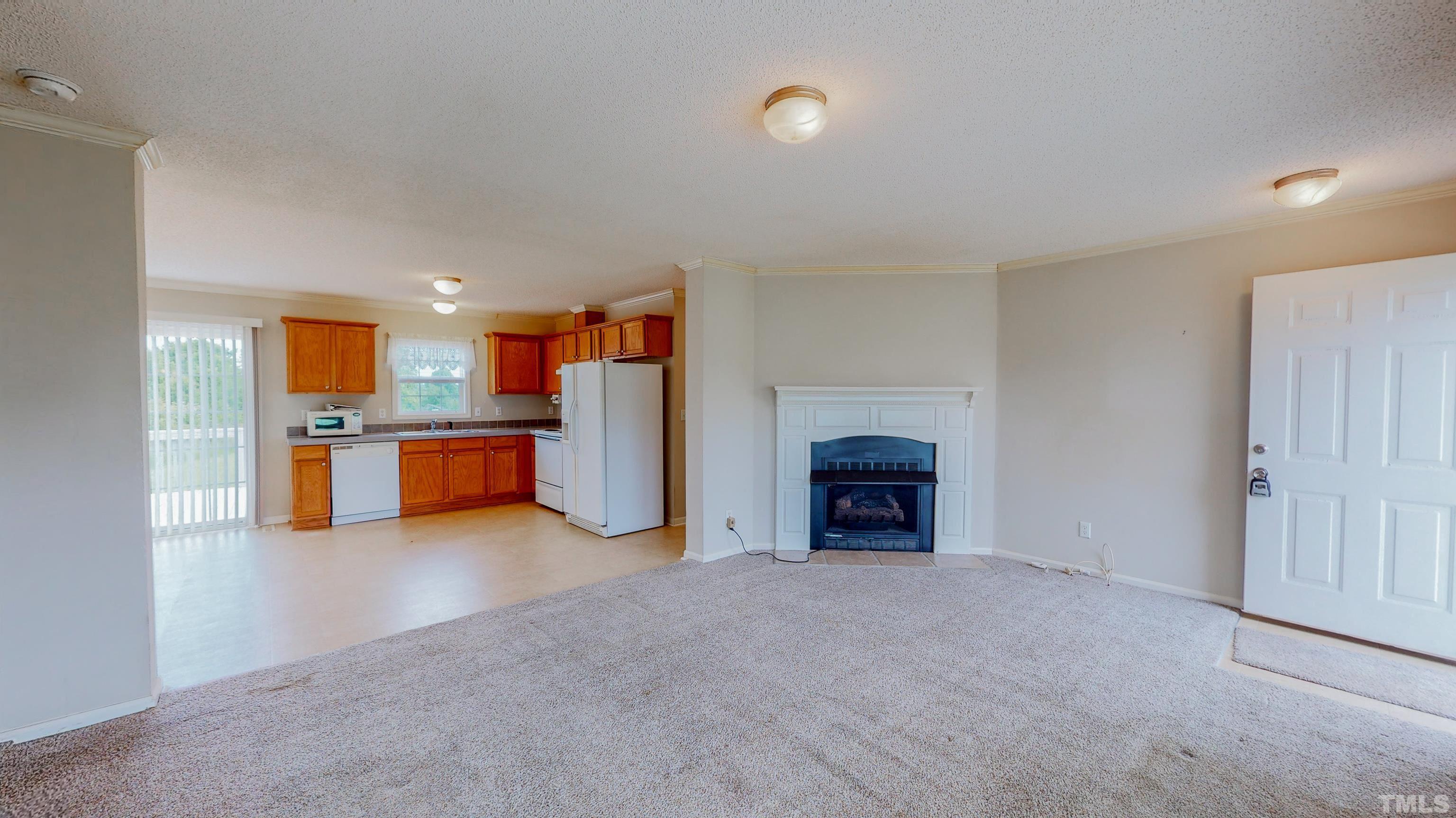 147 Quartergate Road Roxboro, NC 27574 - Photo 4 of 30 a view of a kitchen with a sink and a fireplace
