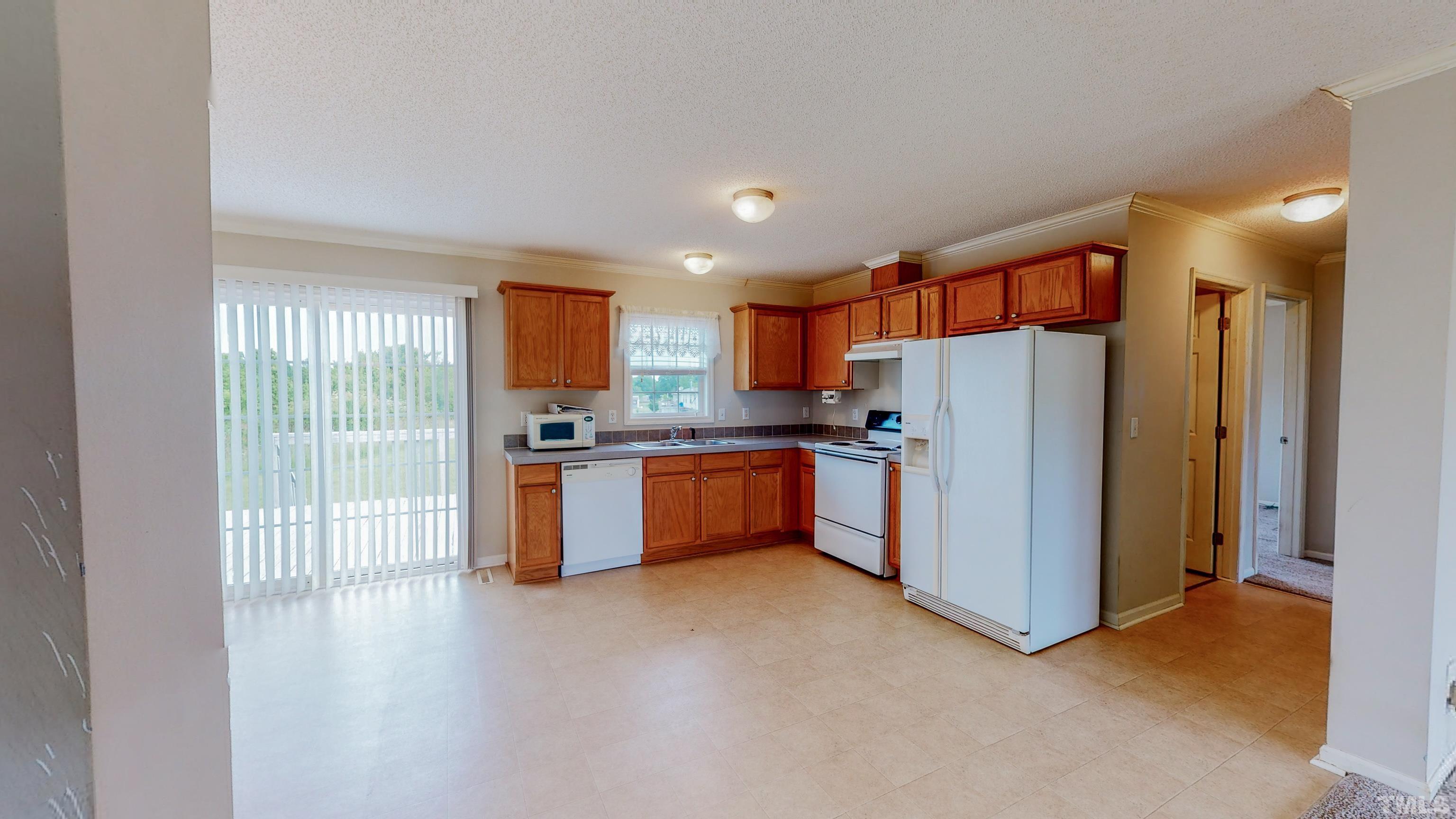 147 Quartergate Road Roxboro, NC 27574 - Photo 5 of 30 a kitchen with stainless steel appliances granite countertop a refrigerator and a sink