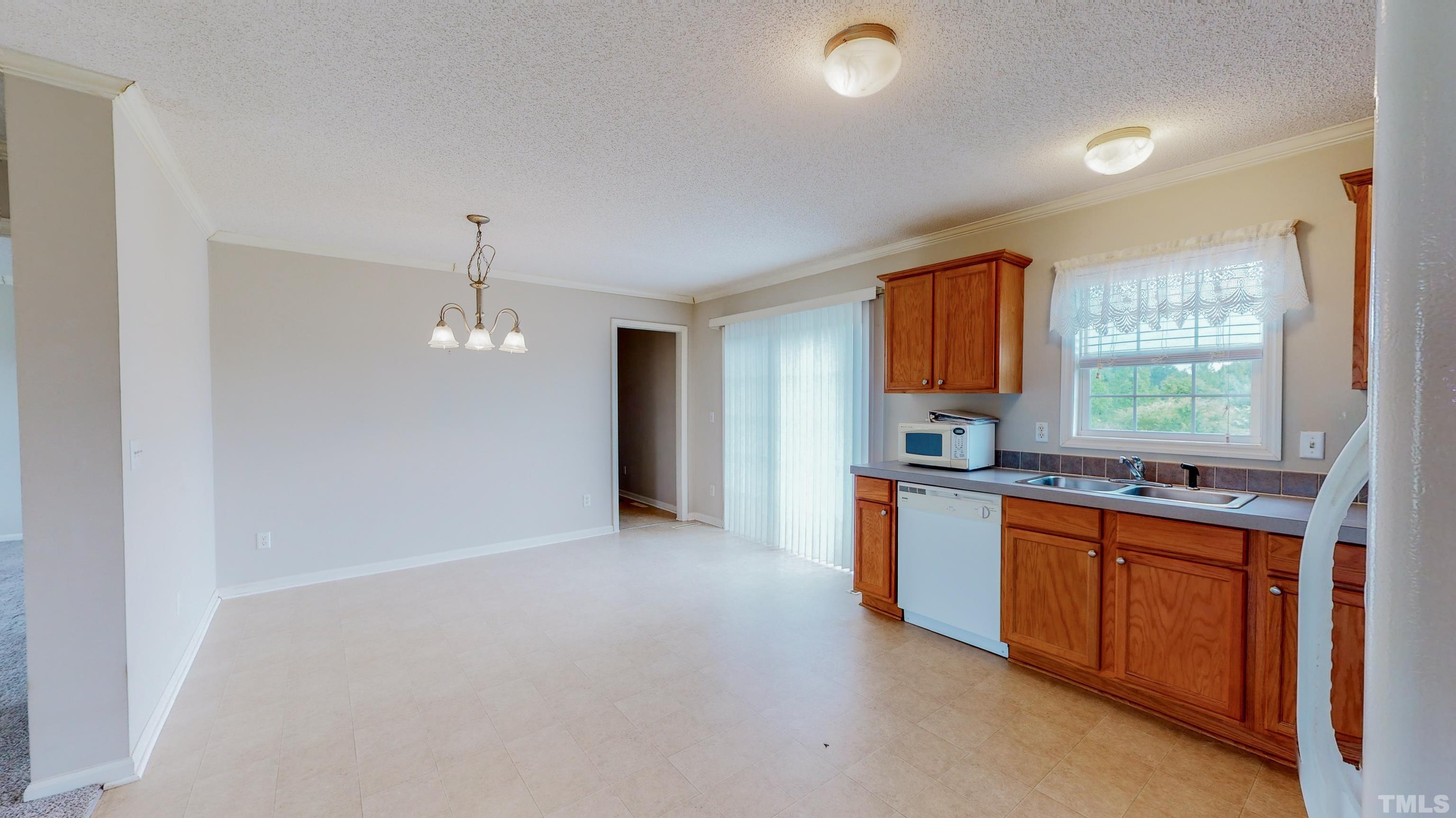 147 Quartergate Road Roxboro, NC 27574 - Photo 6 of 30 a open kitchen with stainless steel appliances granite countertop a refrigerator a sink dishwasher a stove and a refrigerator with wooden floor