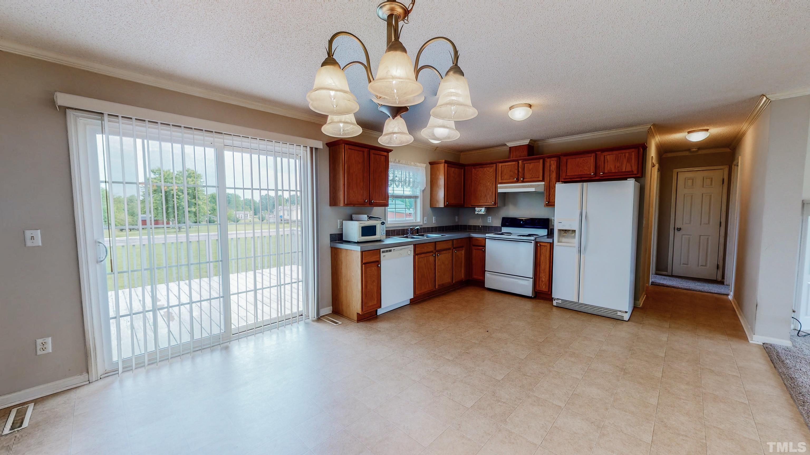 147 Quartergate Road Roxboro, NC 27574 - Photo 7 of 30 a view of a kitchen with a sink stainless steel appliances and cabinets