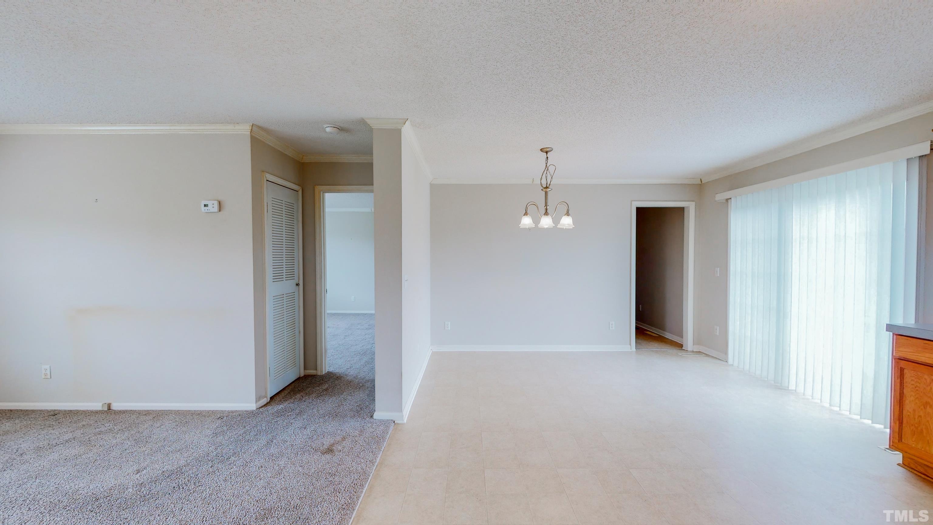 147 Quartergate Road Roxboro, NC 27574 - Photo 8 of 30 an empty room with kitchen view and natural light