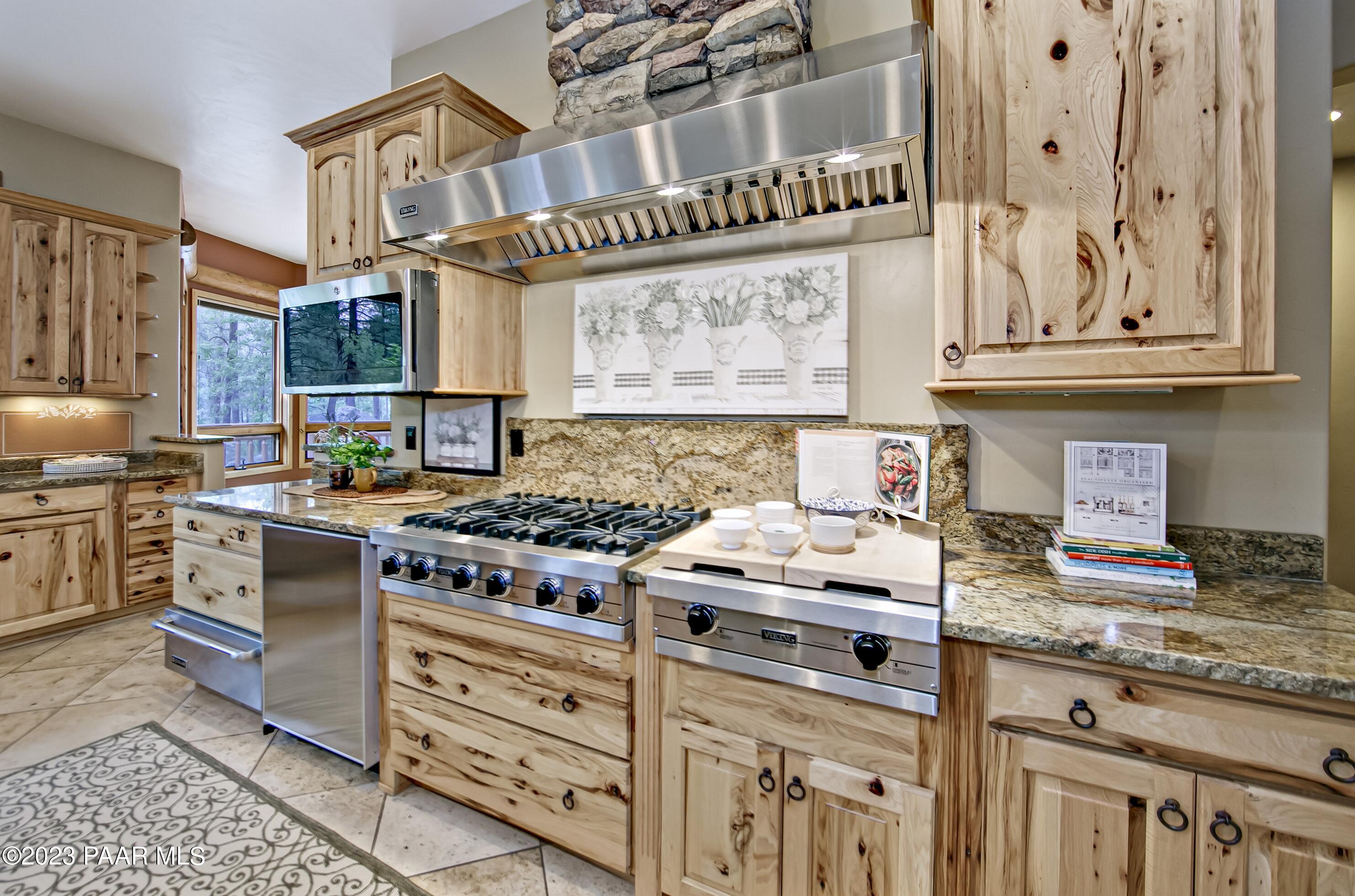 5140 East Charcoal Kiln Road Prescott, AZ 86303 - Photo 15 of 77 a kitchen with stainless steel appliances granite countertop a stove and cabinets