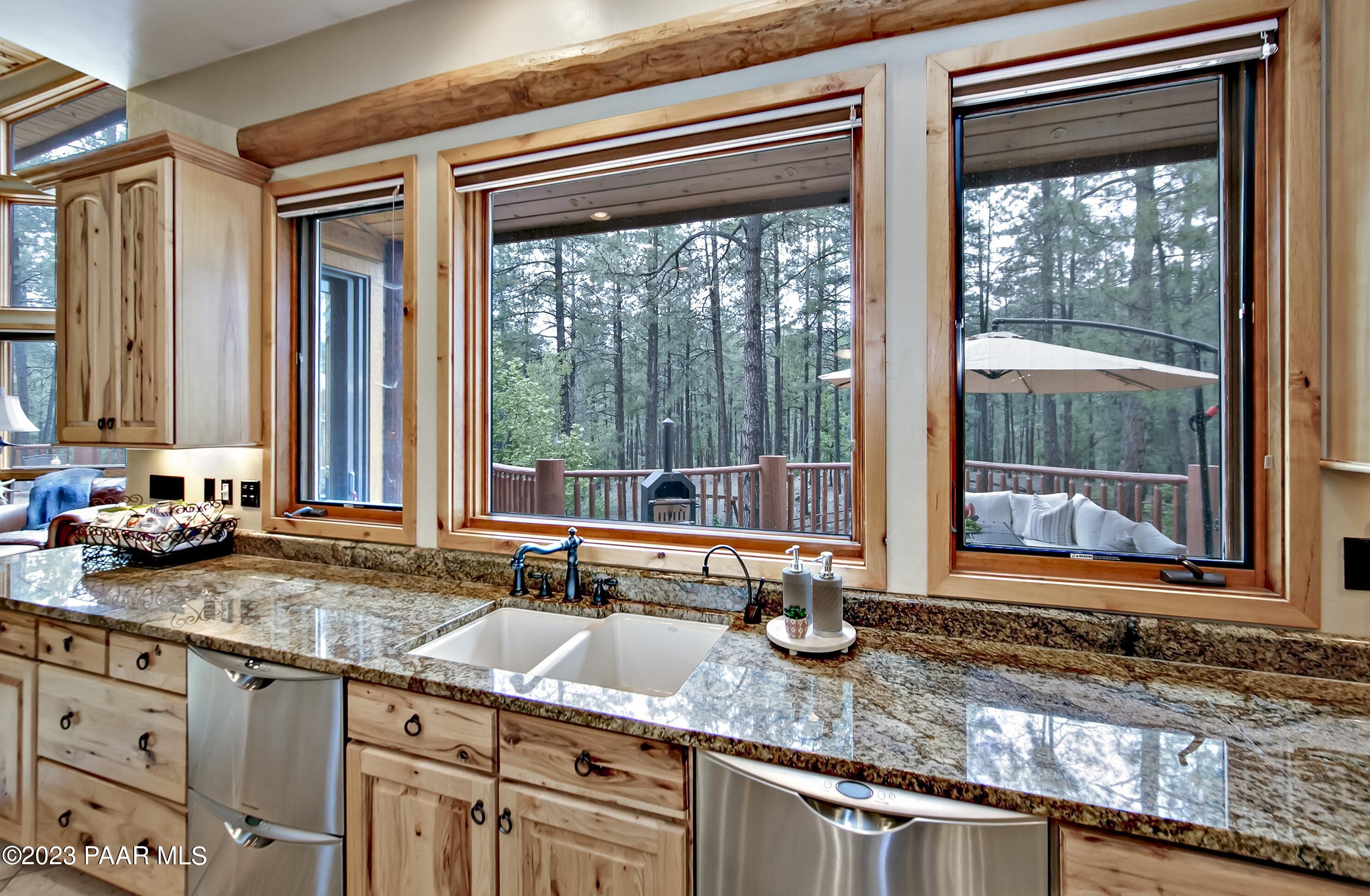 5140 East Charcoal Kiln Road Prescott, AZ 86303 - Photo 16 of 77 a kitchen with granite countertop a sink and a window