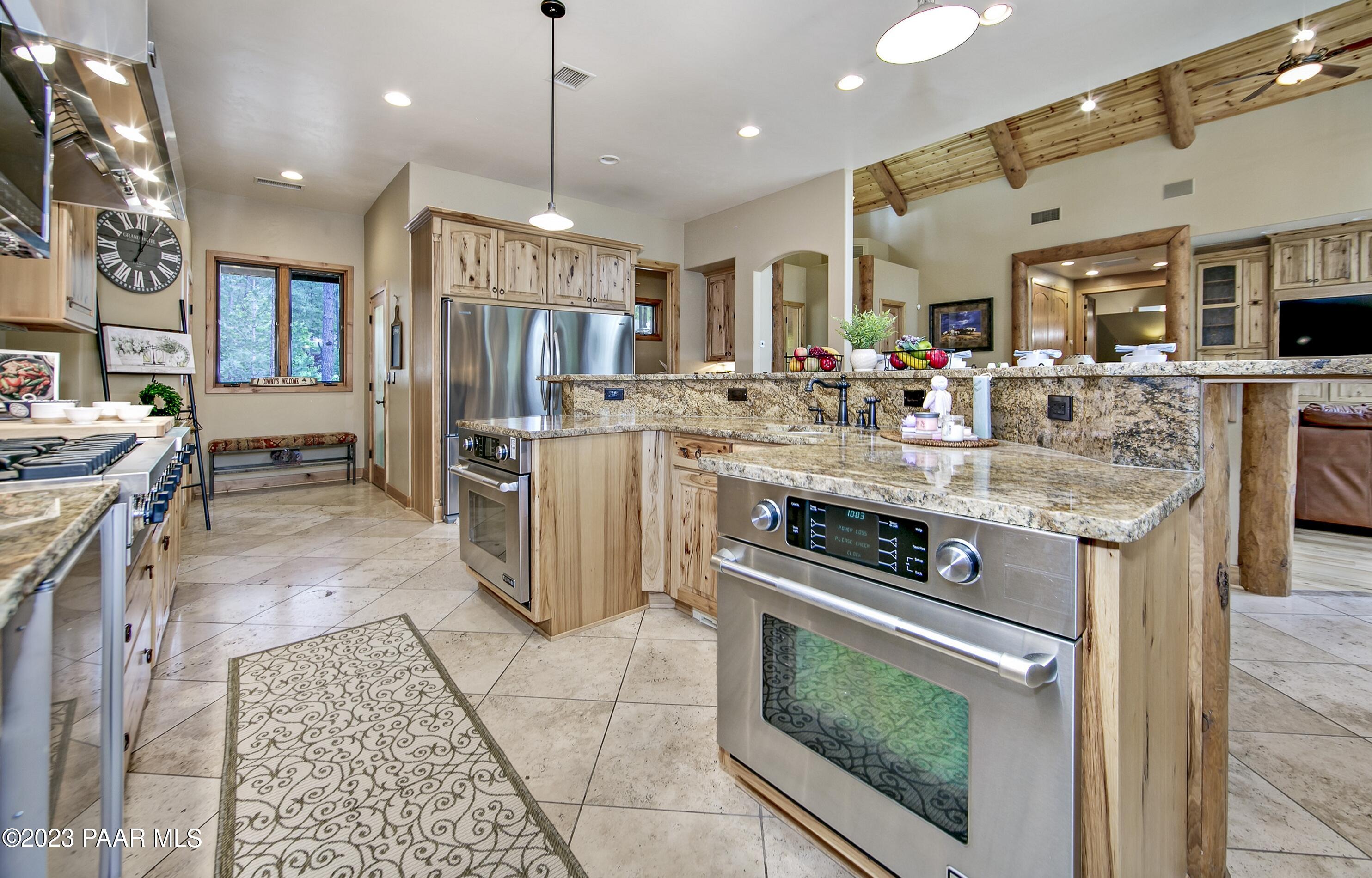 5140 East Charcoal Kiln Road Prescott, AZ 86303 - Photo 17 of 77 a kitchen with stainless steel appliances granite countertop a stove top oven a sink dishwasher and a refrigerator with the cabinets