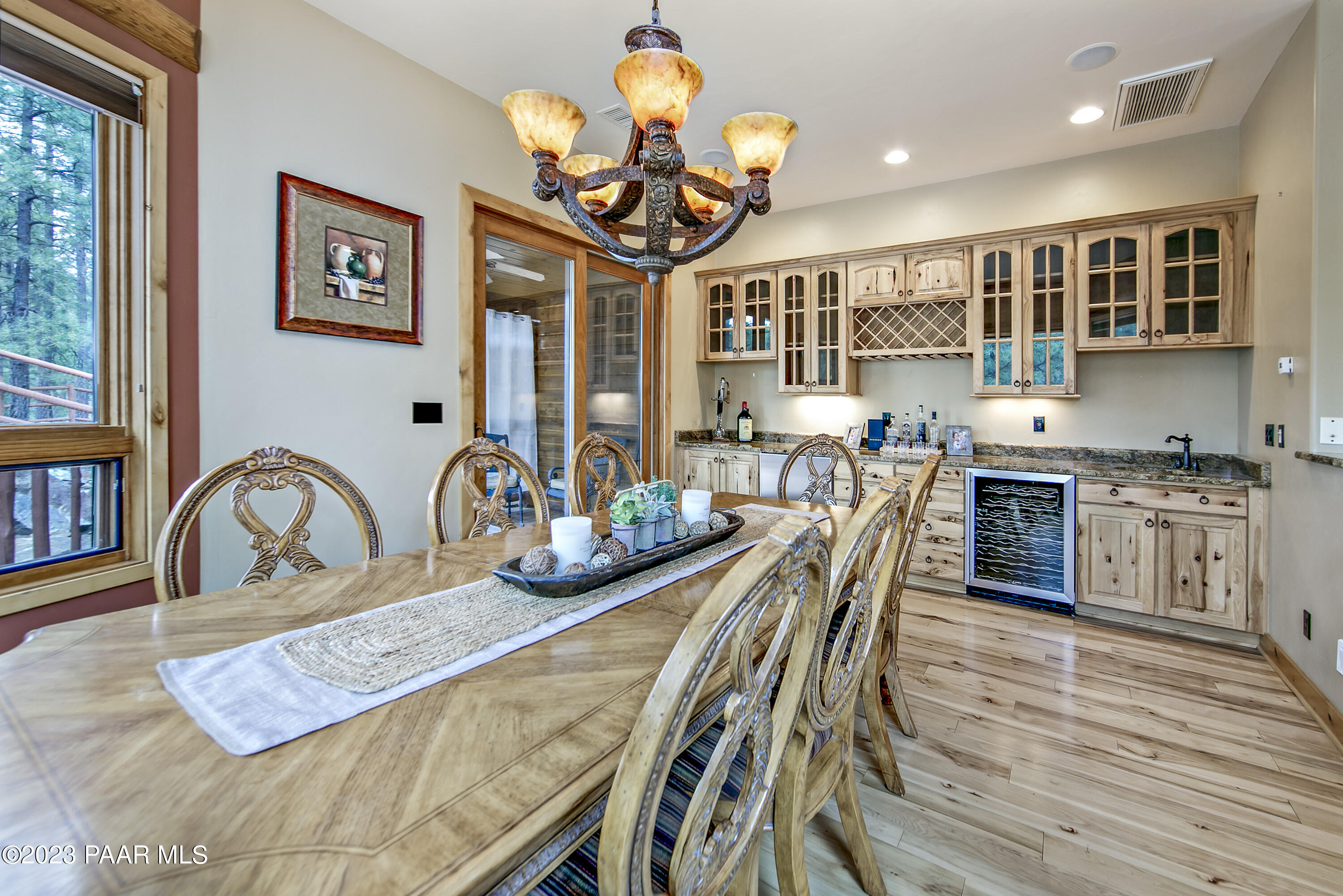 5140 East Charcoal Kiln Road Prescott, AZ 86303 - Photo 18 of 77 a view of a dining room with furniture a chandelier and wooden floor