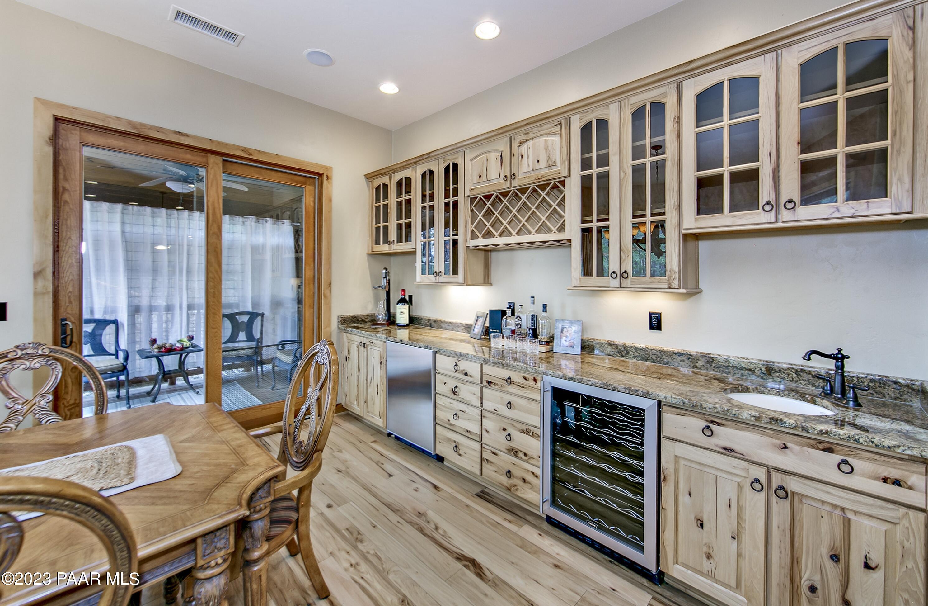 5140 East Charcoal Kiln Road Prescott, AZ 86303 - Photo 19 of 77 a kitchen with a table chairs stove and cabinets