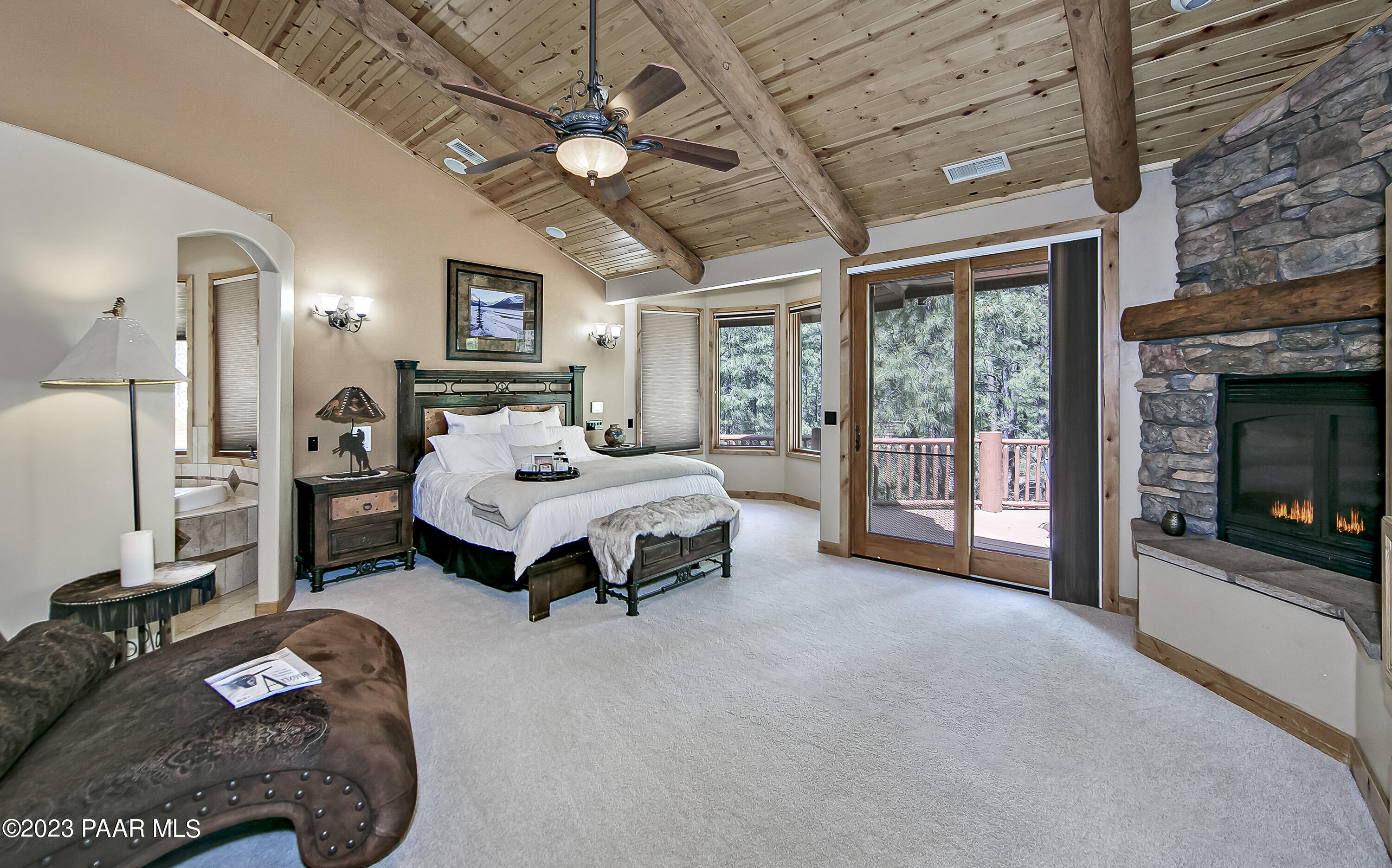 5140 East Charcoal Kiln Road Prescott, AZ 86303 - Photo 23 of 77 a bedroom with a bed a flat screen tv and a fireplace