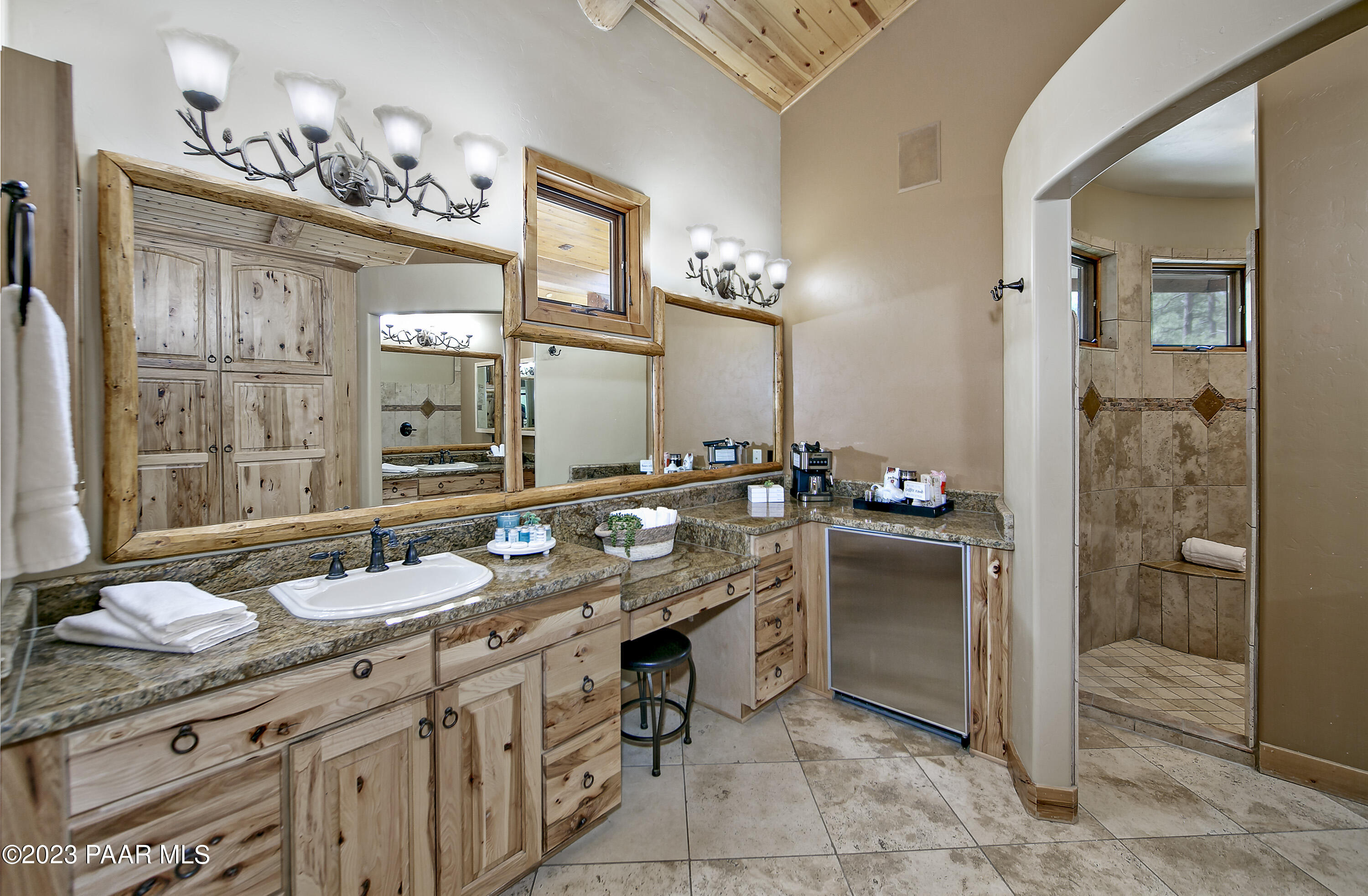 5140 East Charcoal Kiln Road Prescott, AZ 86303 - Photo 25 of 77 a bathroom with a granite countertop sink a mirror and a shower