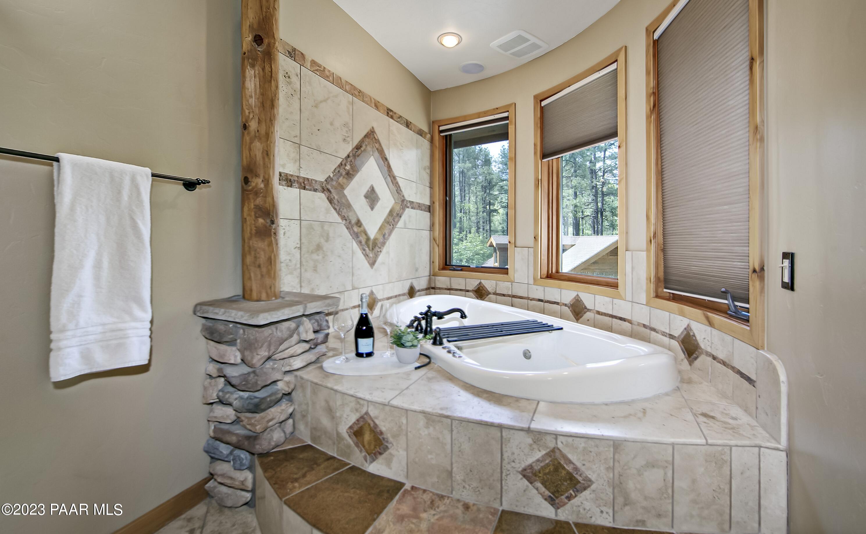 5140 East Charcoal Kiln Road Prescott, AZ 86303 - Photo 27 of 77 a bathroom with a tub sink and mirror