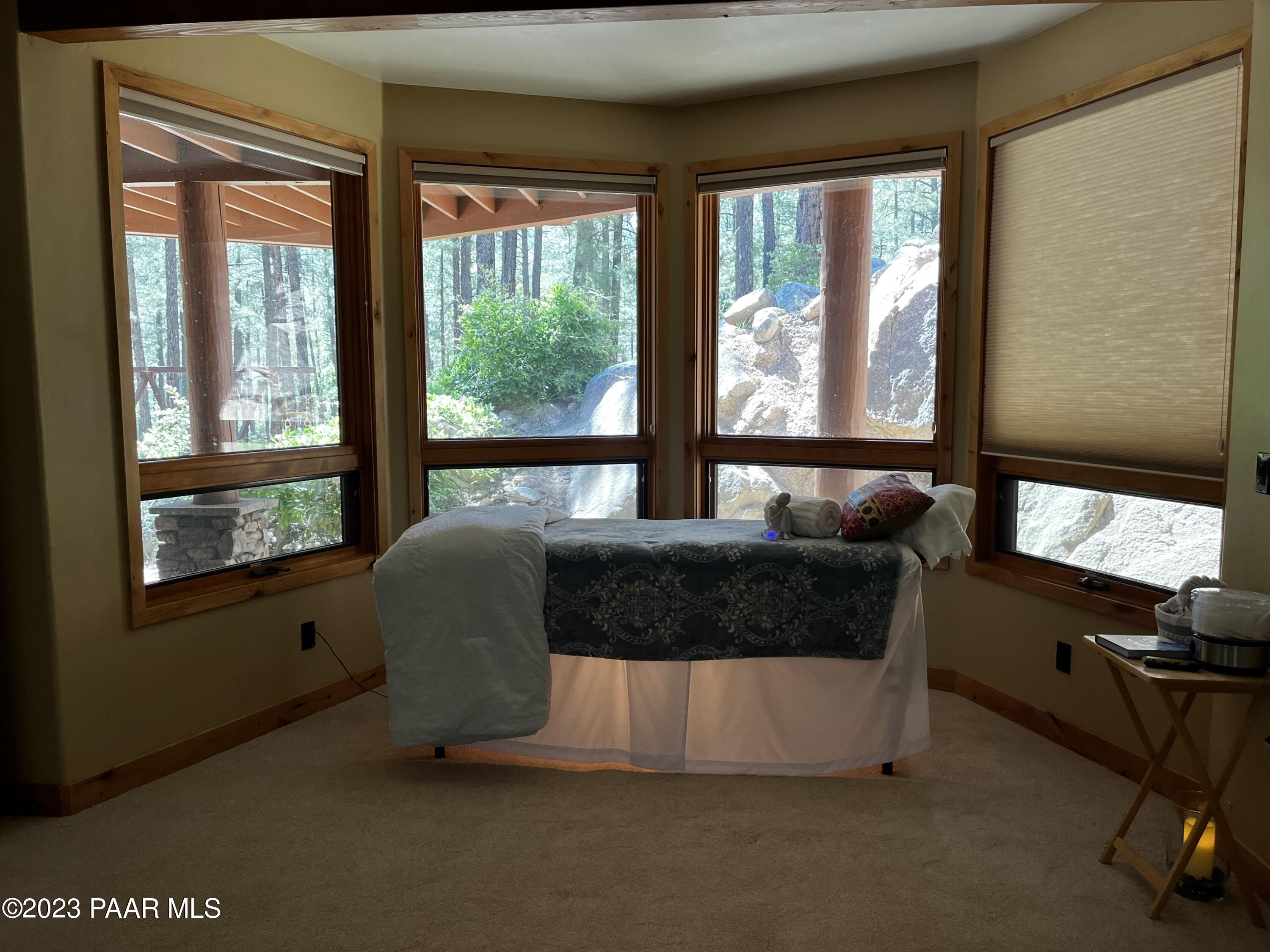 5140 East Charcoal Kiln Road Prescott, AZ 86303 - Photo 36 of 77 a living room with furniture and a floor to ceiling window