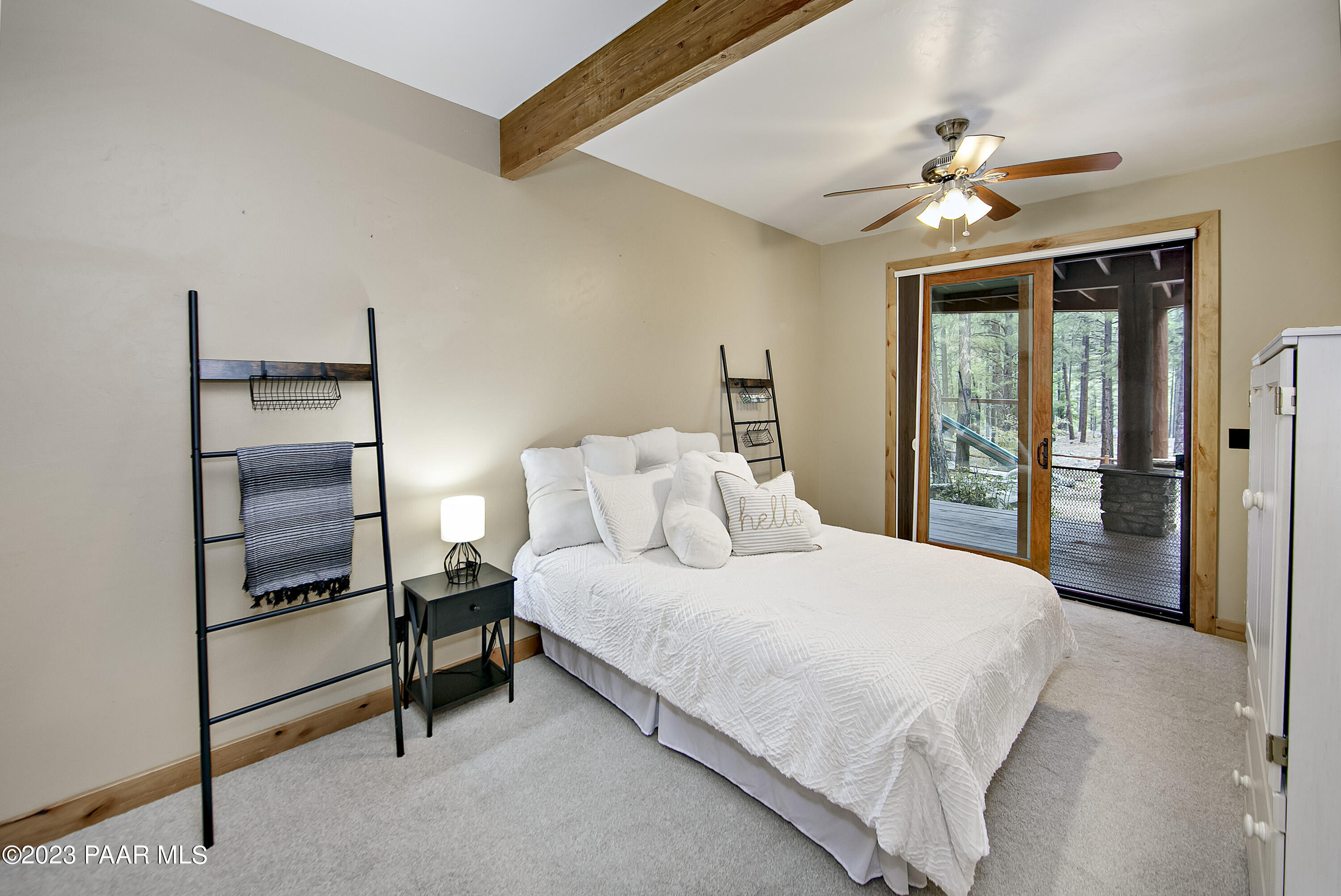 5140 East Charcoal Kiln Road Prescott, AZ 86303 - Photo 40 of 77 a bedroom with a bed and a chandelier