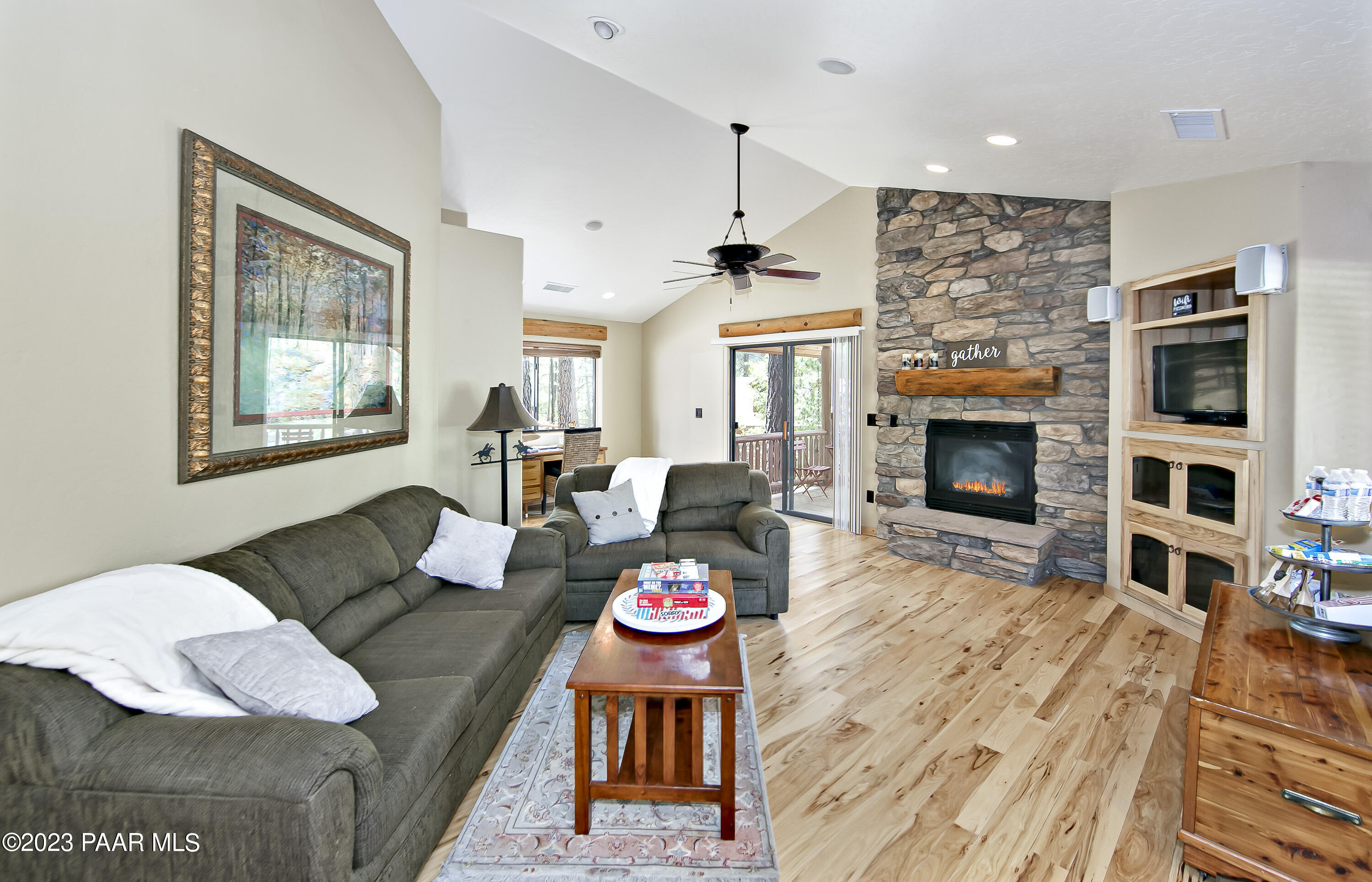 5140 East Charcoal Kiln Road Prescott, AZ 86303 - Photo 63 of 77 a living room with furniture kitchen view and a fireplace