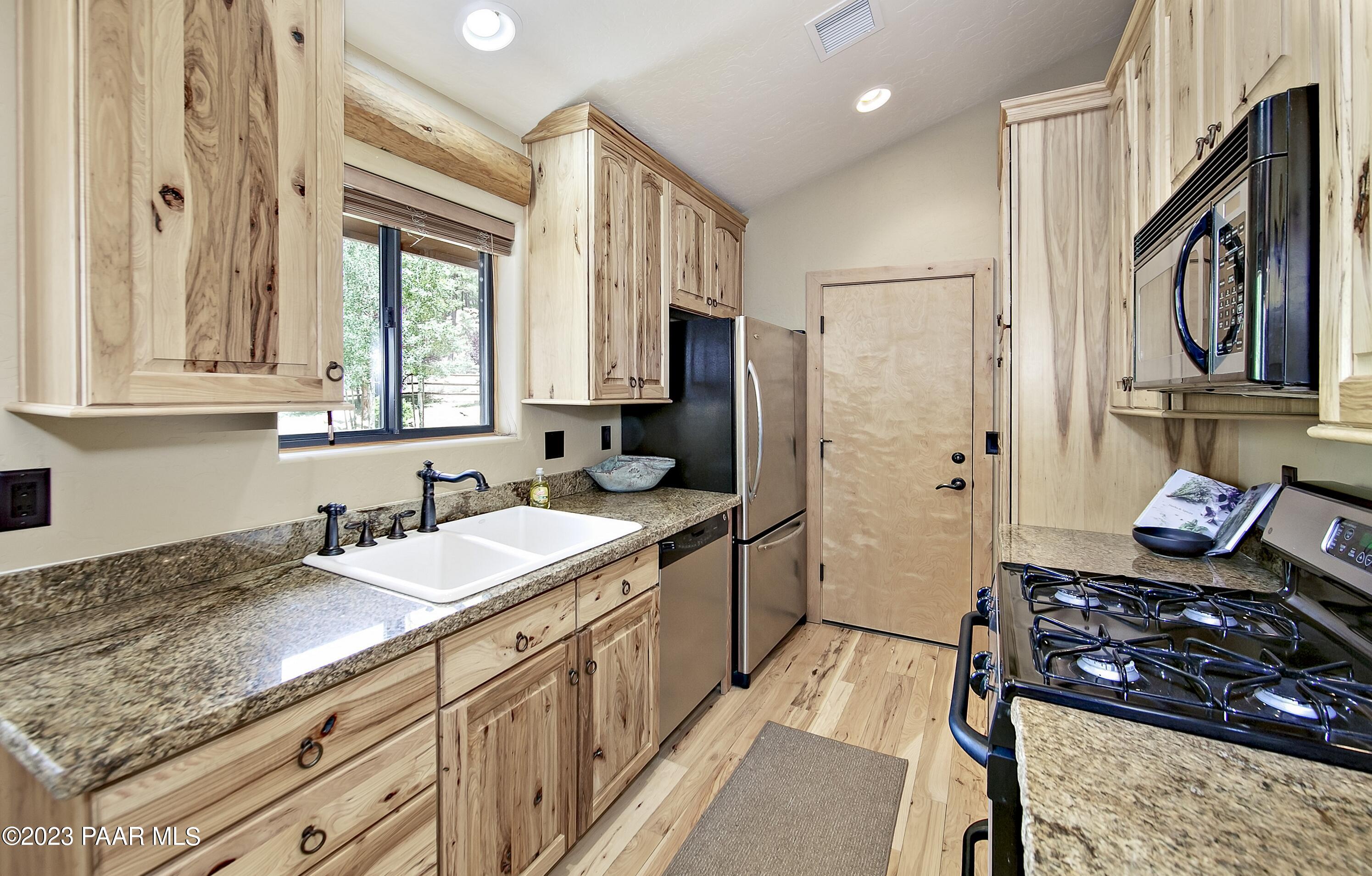 5140 East Charcoal Kiln Road Prescott, AZ 86303 - Photo 64 of 77 a kitchen with stainless steel appliances granite countertop a stove a sink and a refrigerator