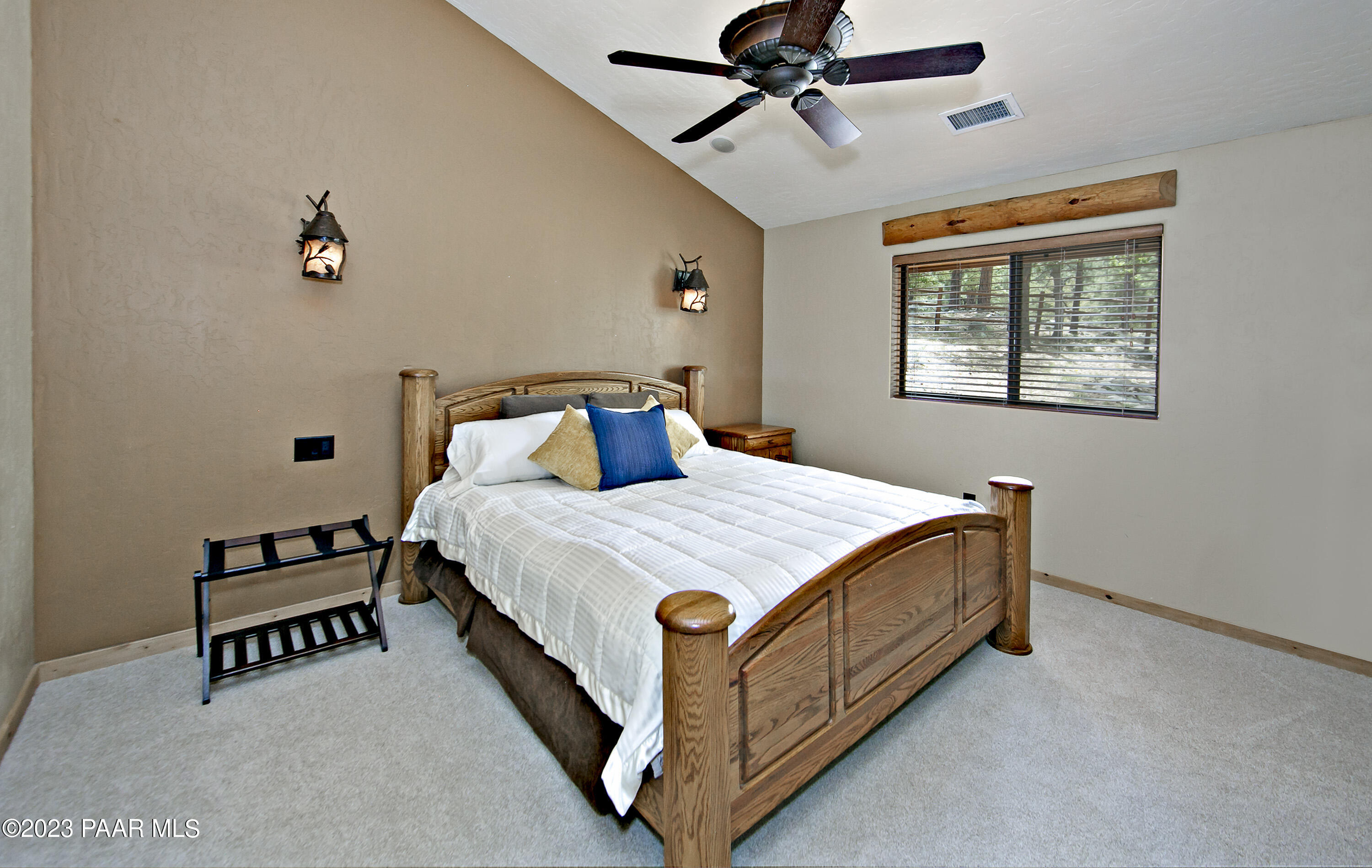 5140 East Charcoal Kiln Road Prescott, AZ 86303 - Photo 67 of 77 a bed sitting in a bedroom next to a window