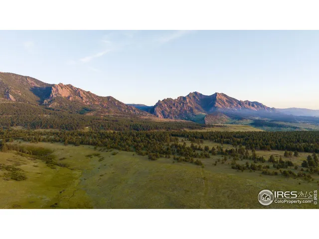 a open area with mountains in the background