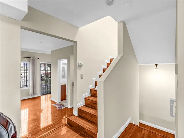 a view of an entryway with wooden floor and staircase