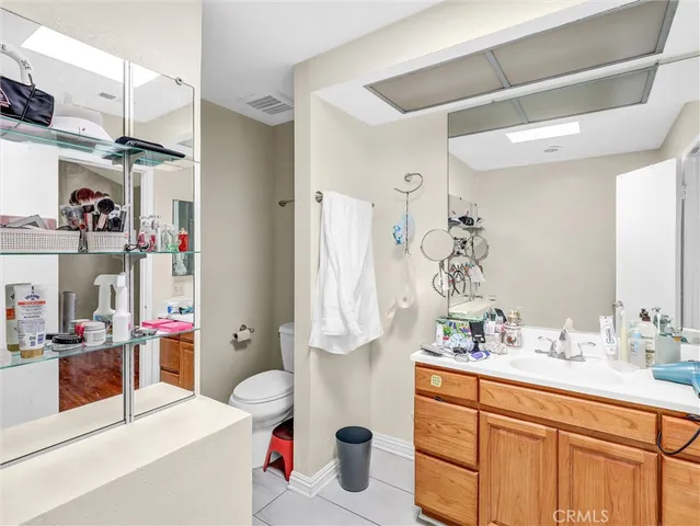 a bathroom with a sink vanity mirror and toilet