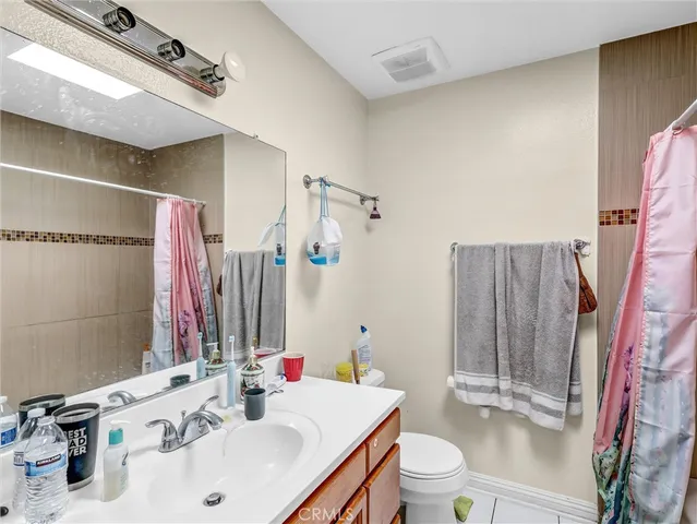 a bathroom with a sink vanity mirror and toilet