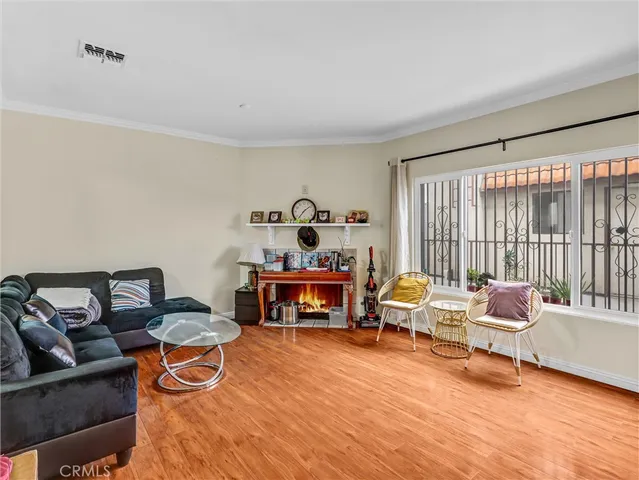 a living room with furniture and a floor to ceiling window
