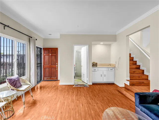 a view of a livingroom with furniture and staircase