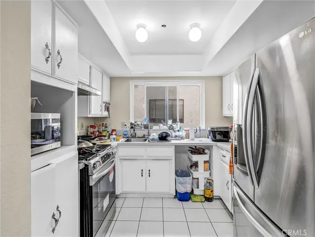 a kitchen with stainless steel appliances a sink stove and refrigerator