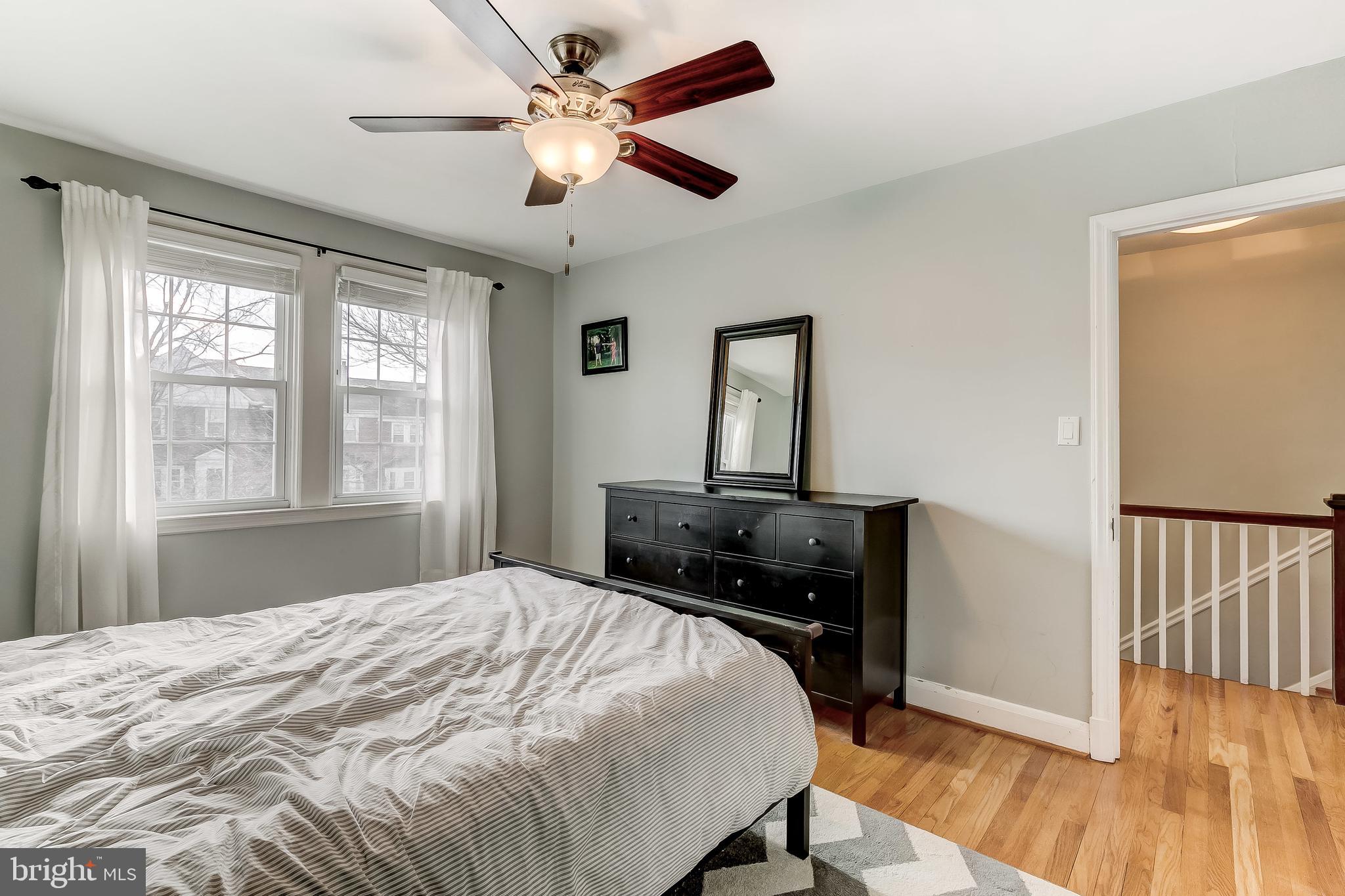 142 Hopkins Road Baltimore, MD 21212 - Photo 22 of 38 a bedroom with a bed and wooden floor