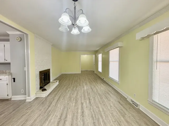 a view of a livingroom with wooden floor and a large window