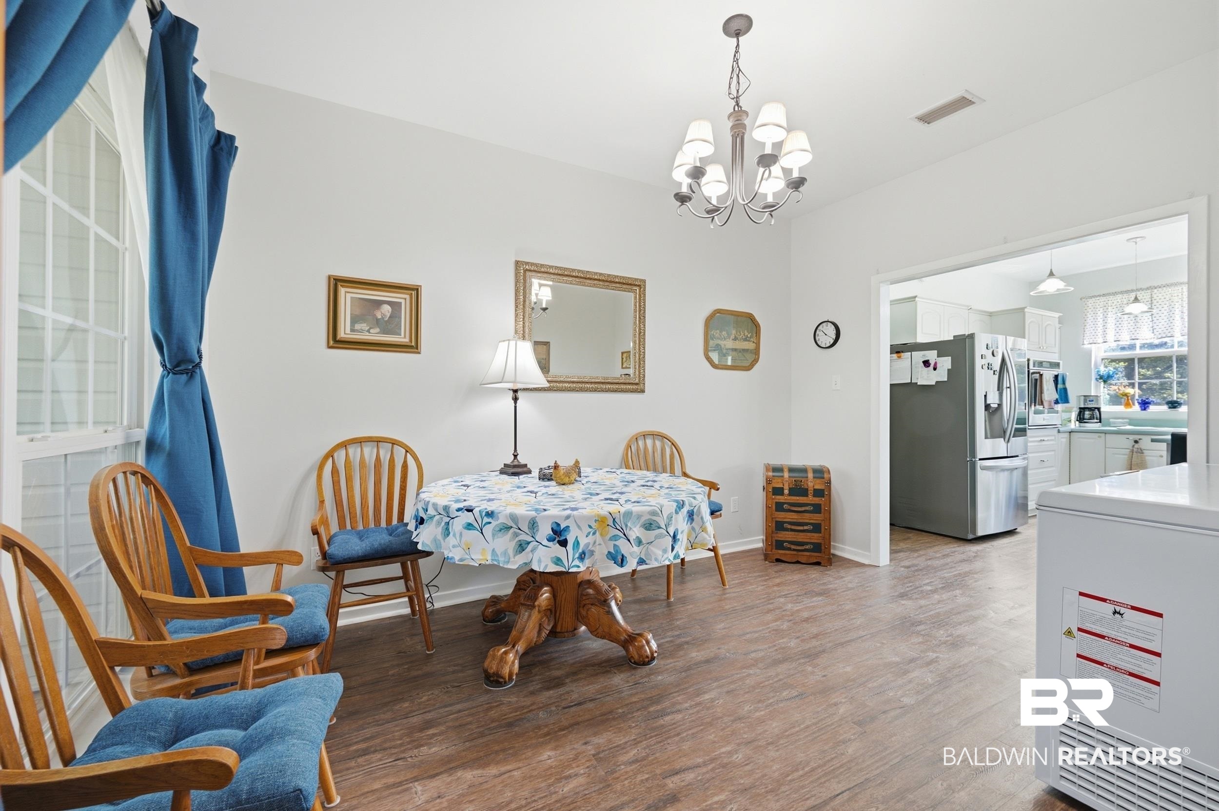 15855 Calvin Richerson Road Bay Minette, AL 36507 - Photo 41 of 83 Bright room featuring wood-finish flooring and a central chandelier