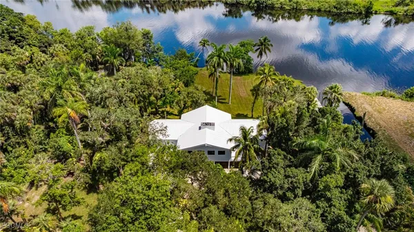 a aerial view of a house with a yard and a garden