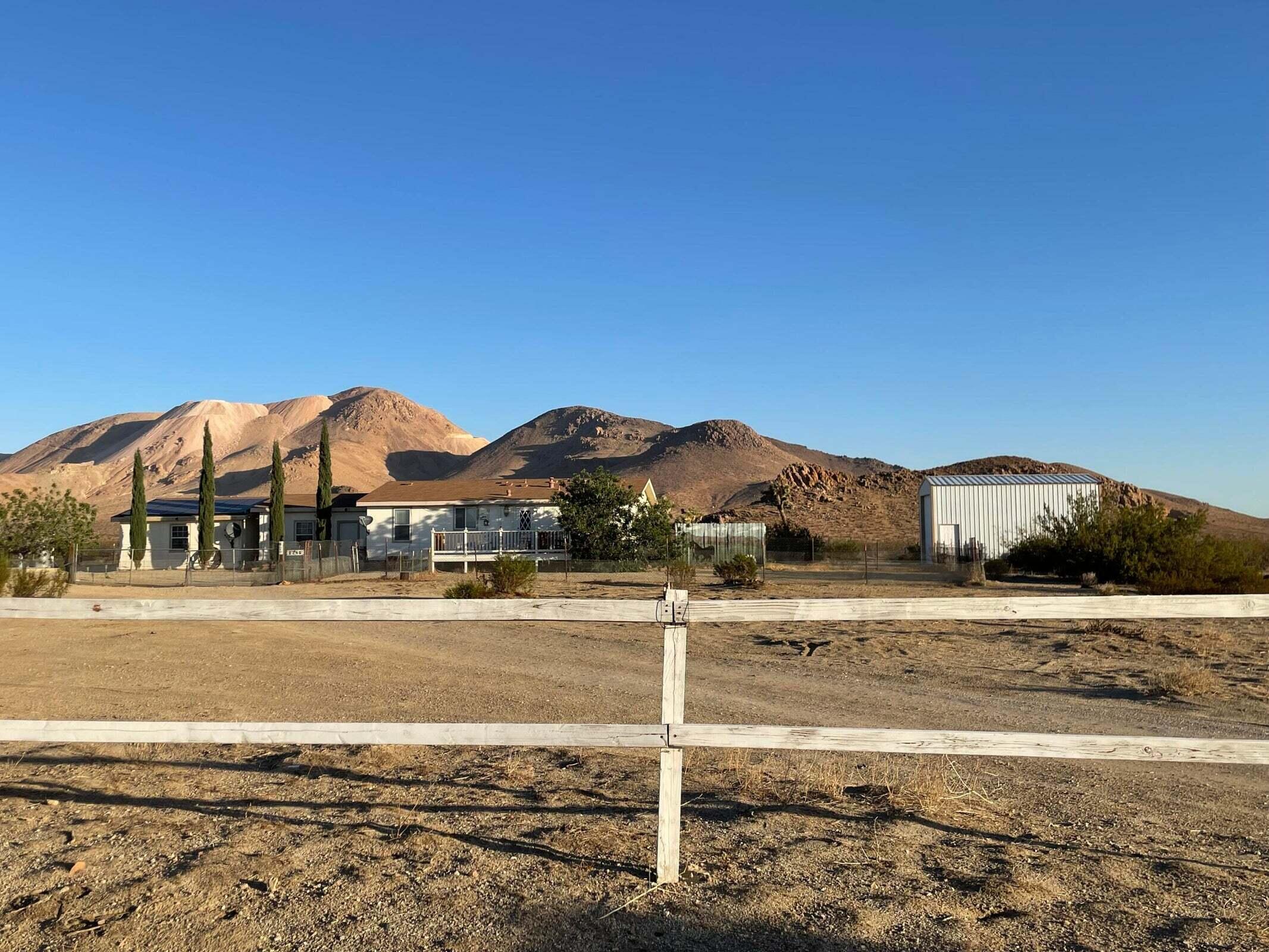 2285 Backus Road Mojave, CA 93501 - Photo 28 of 35 a view of a large house with a big yard and large trees