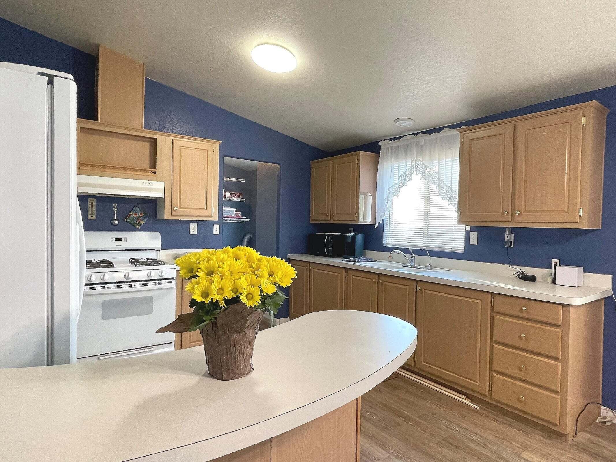 2285 Backus Road Mojave, CA 93501 - Photo 5 of 35 a kitchen with stainless steel appliances kitchen island granite countertop a sink a stove and cabinets