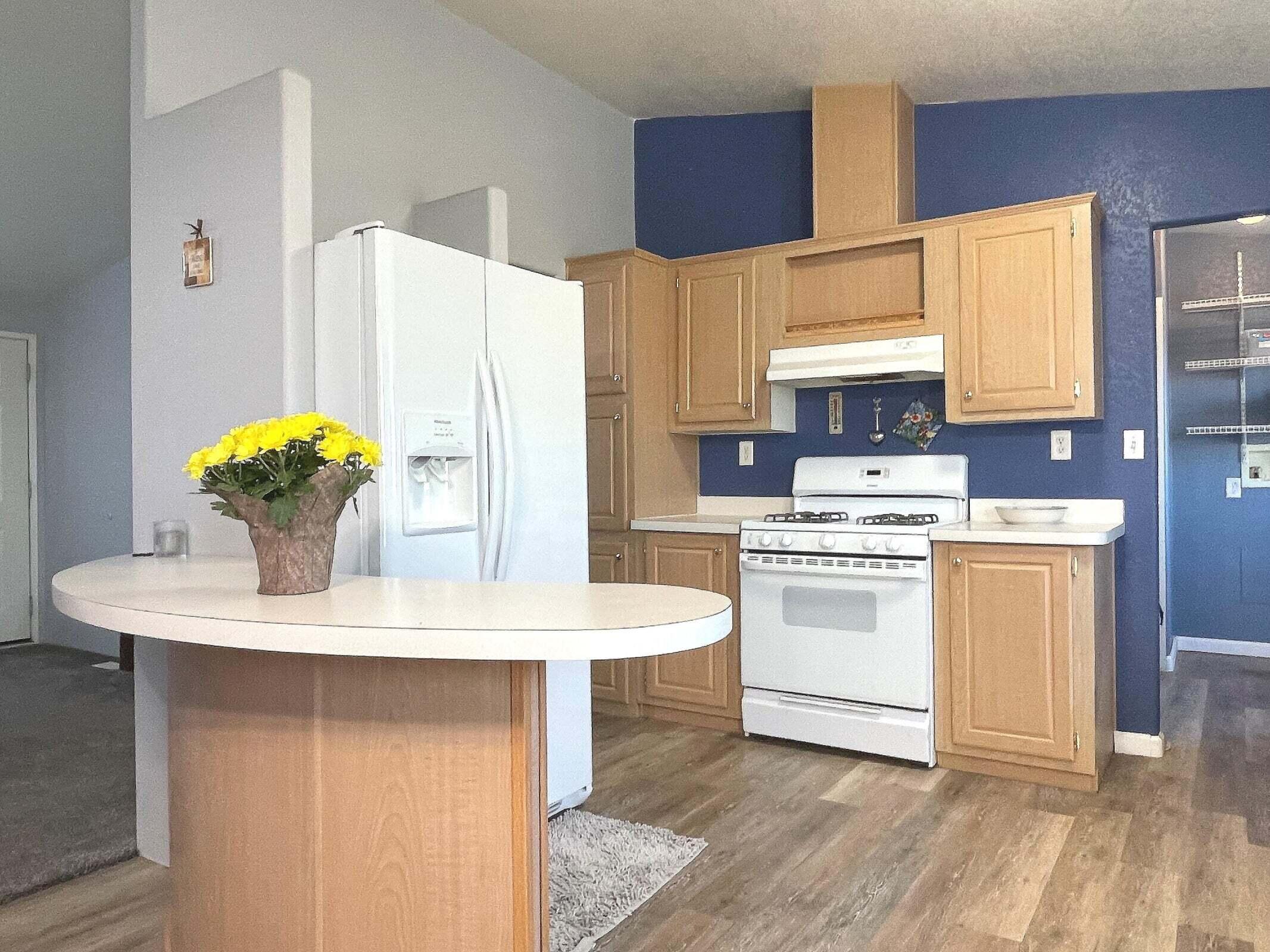 2285 Backus Road Mojave, CA 93501 - Photo 6 of 35 a kitchen with a white stove top oven and white countertops
