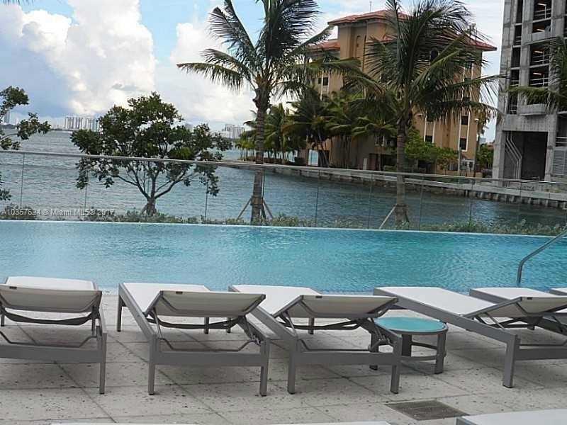 460 Northeast 28th Street, Unit 2001 Miami, FL 33137 - Photo 17 of 28 a backyard of a house with table and chairs