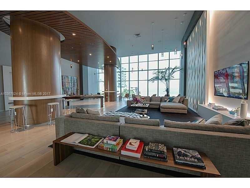 460 Northeast 28th Street, Unit 2001 Miami, FL 33137 - Photo 23 of 28 a living room with furniture and a flat screen tv