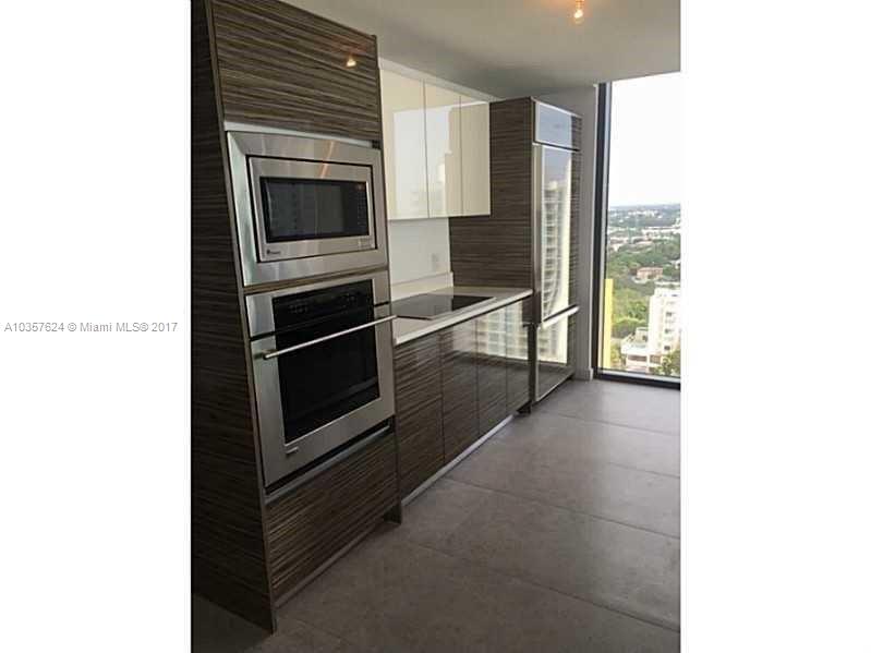 460 Northeast 28th Street, Unit 2001 Miami, FL 33137 - Photo 5 of 28 a living room with stainless steel appliances kitchen island granite countertop a stove and a microwave