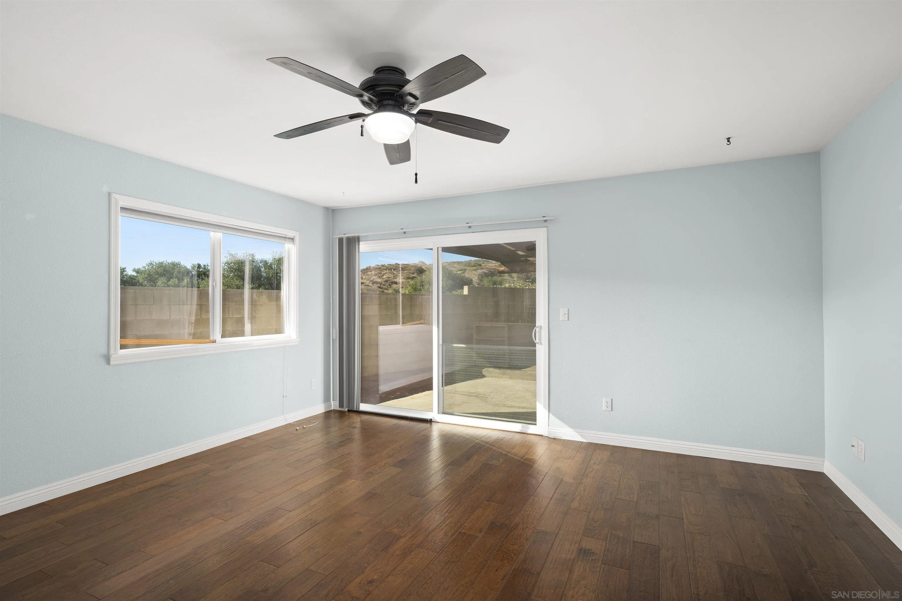 12679 Ridgeton Drive Lakeside, CA 92040 - Photo 15 of 33 an empty room with wooden floor and windows