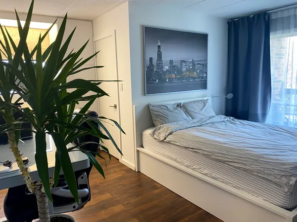a bedroom with a bed and a painting on the wall