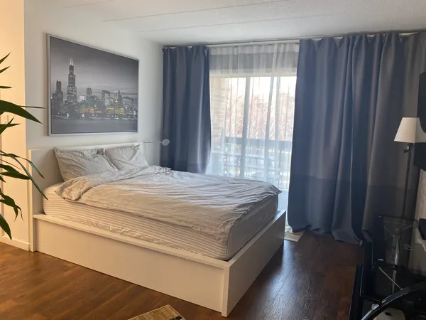 a bedroom with a bed and wooden floor