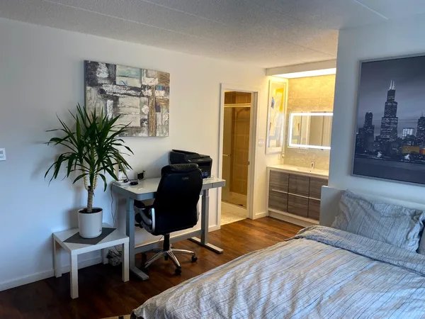 a bedroom with furniture and a window