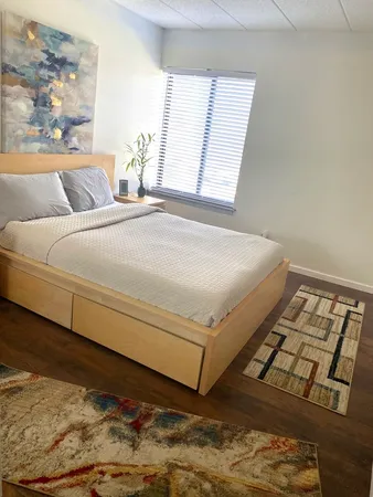 a bedroom with a bed and window